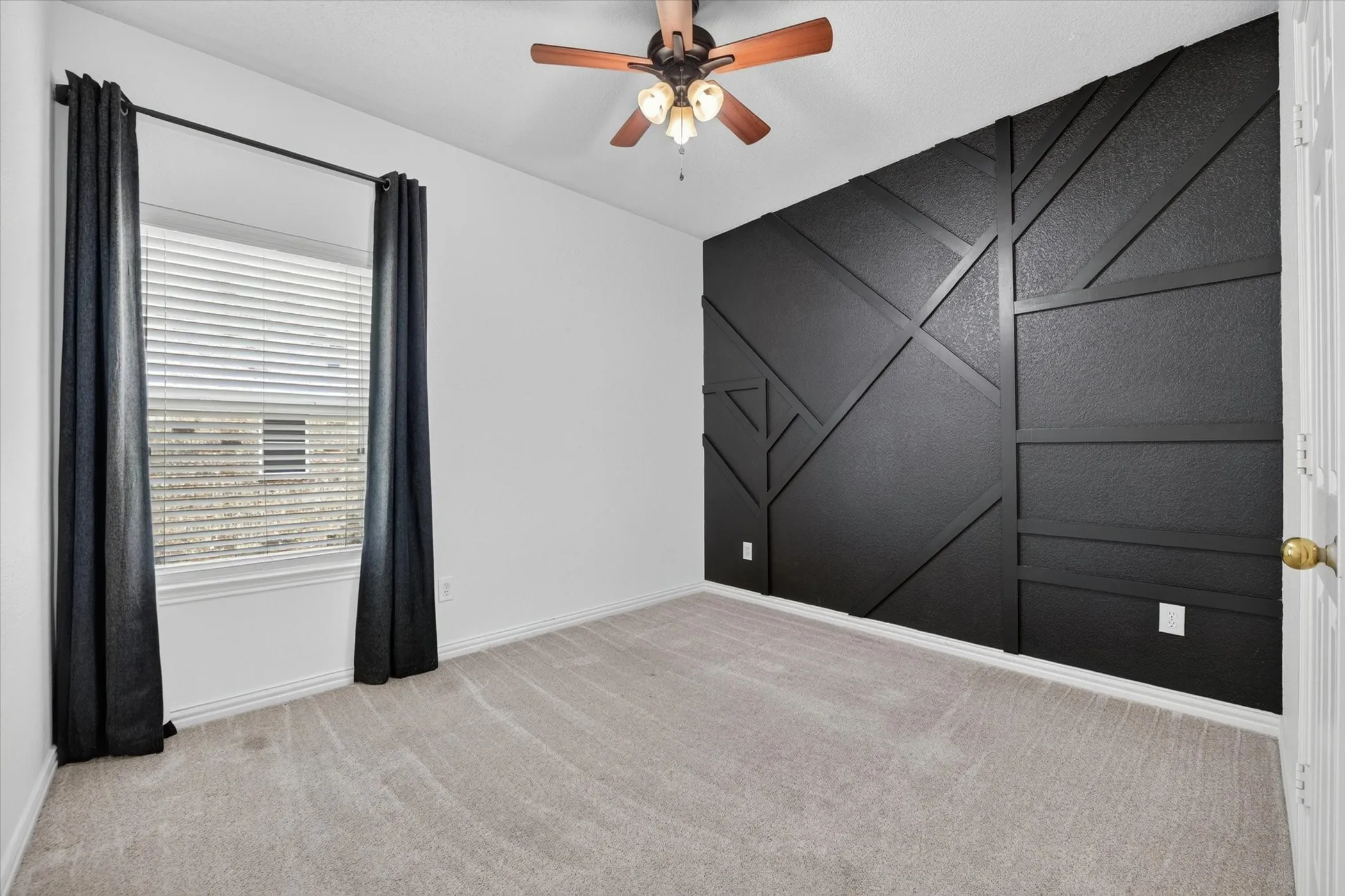 Designer-inspired black geometric accent wall adds a contemporary touch