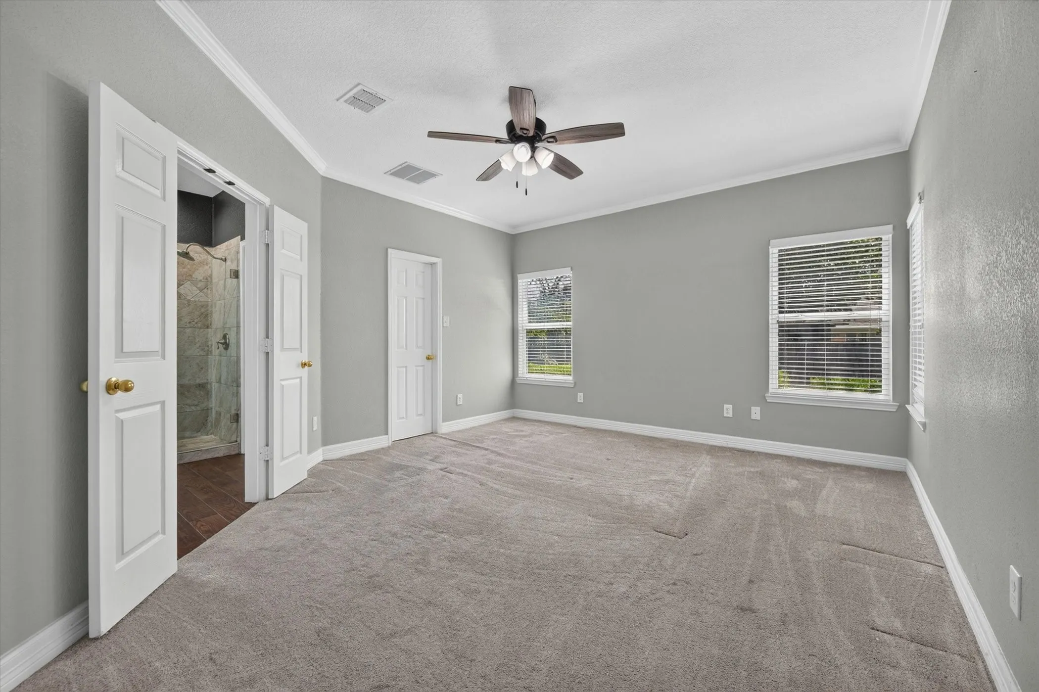 Large primary bedroom with high ceiling