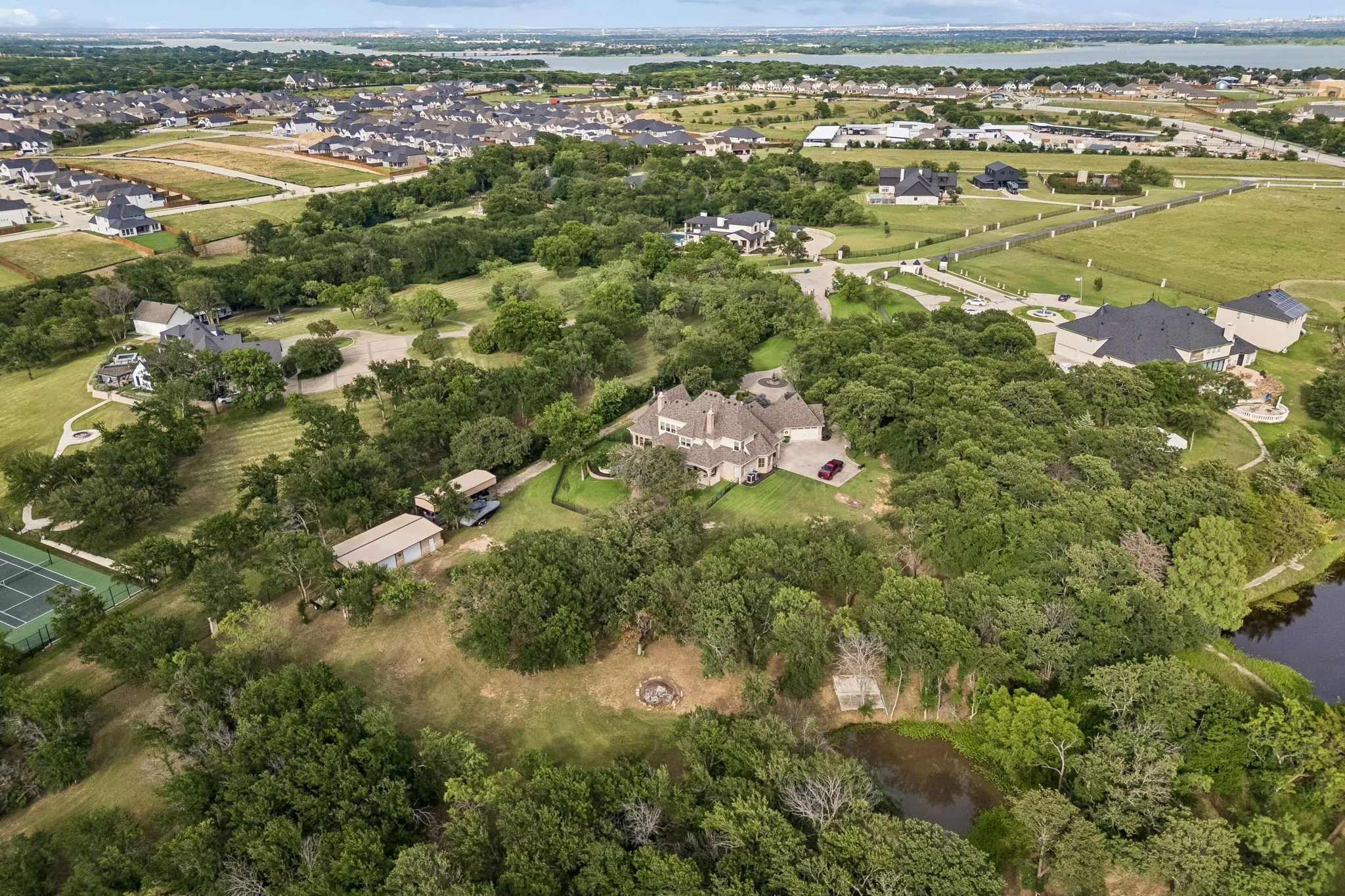 Expansive property with a large residence, surrounded by mature trees
