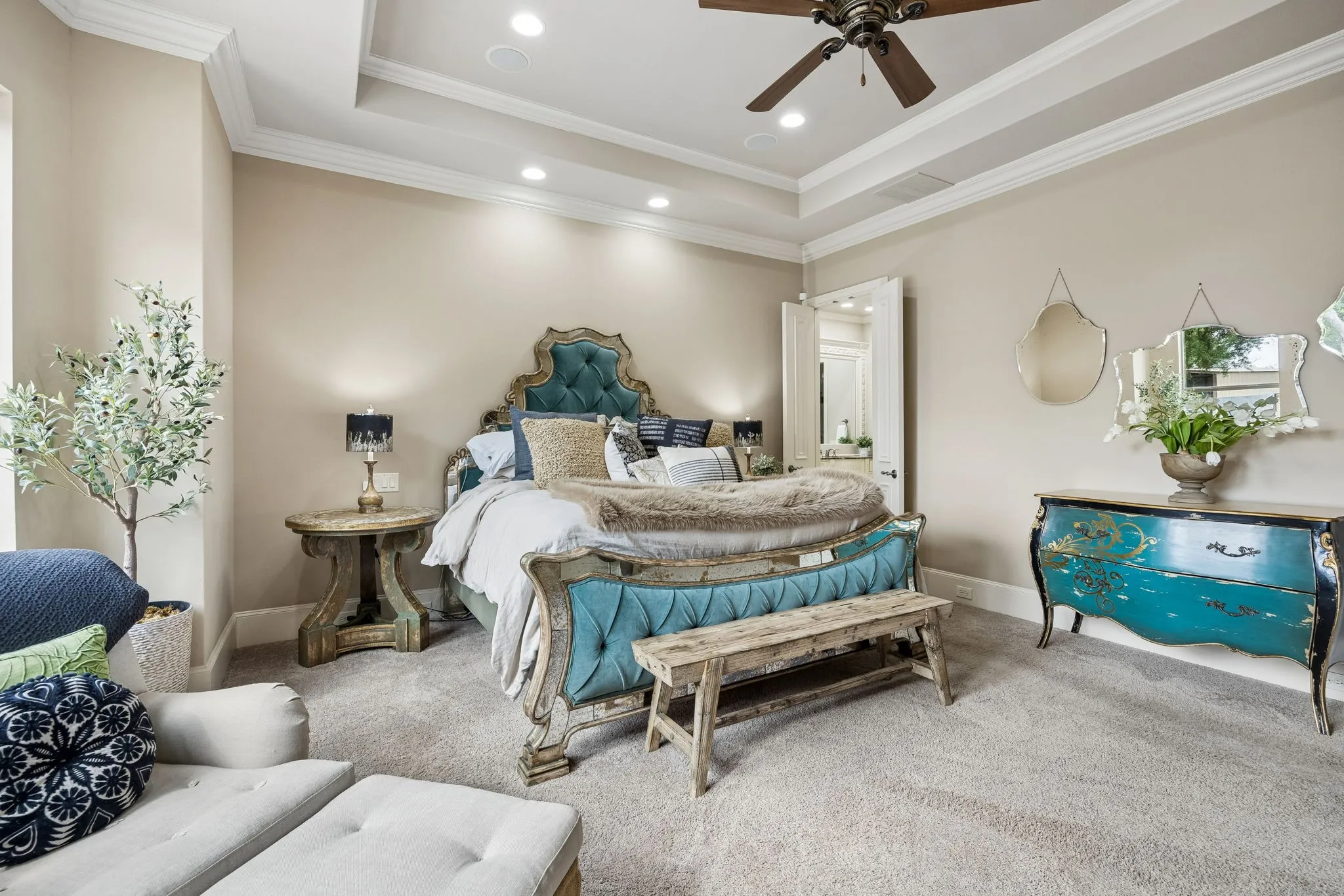 Spacious bedroom featuring plush carpeting and a tray ceiling with recessed lighting