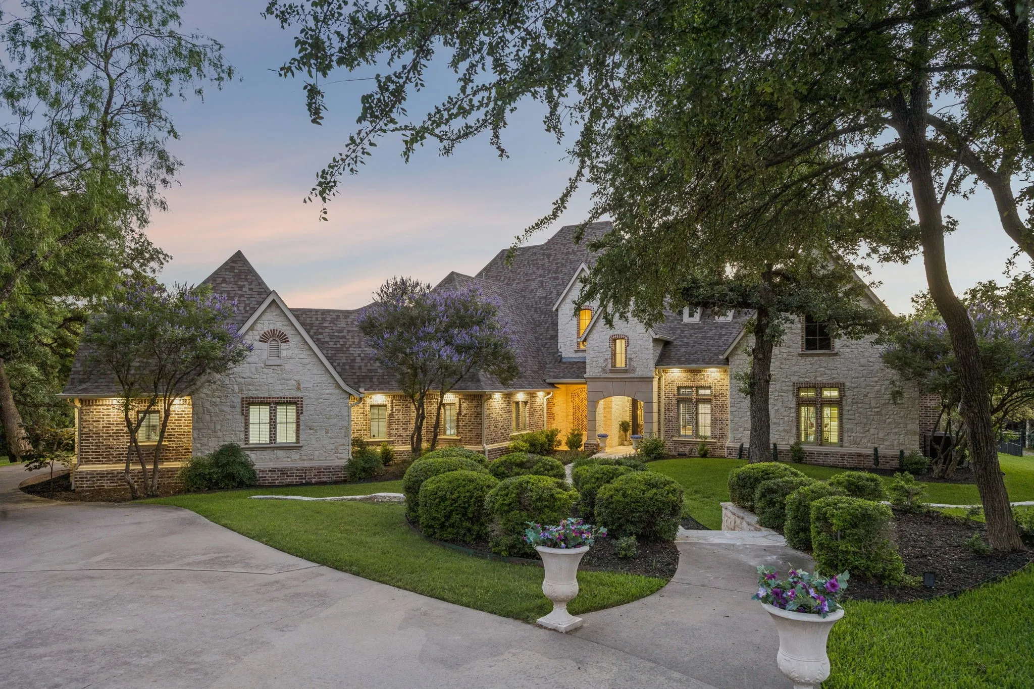 Expansive stone and brick facade residence featuring multiple gables and a multi-level roofline