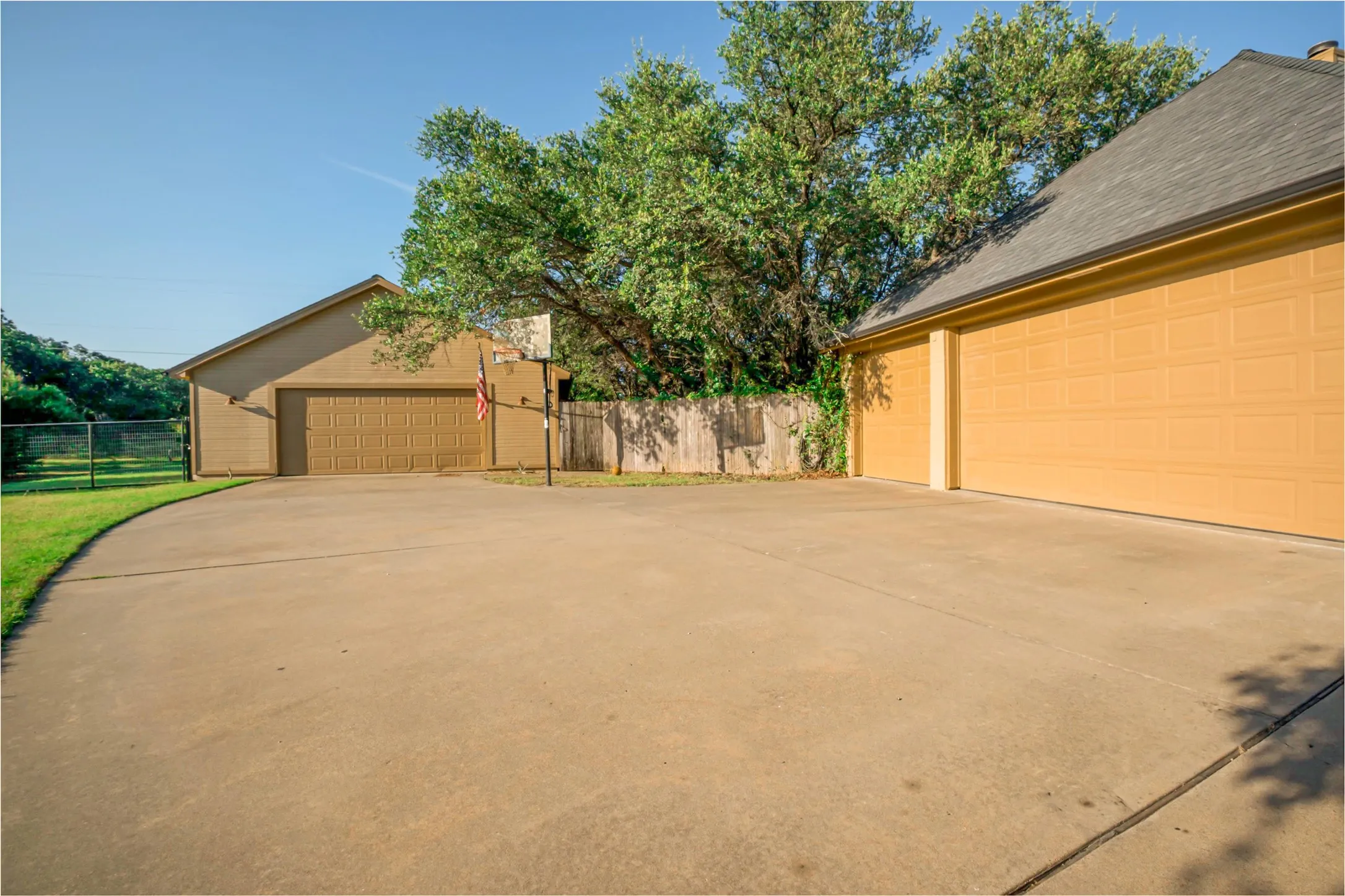 3 car attached garage, a detached 2 car shop and large concrete area for sports.