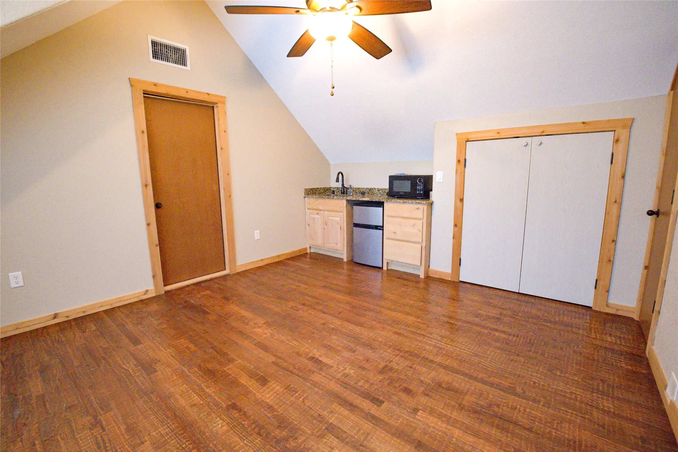 Upstairs flex room with wet bar & hand scraped red oak floors, could be additional living area or 6th bedroom with closet. 2nd of only 2 rooms upstairs.