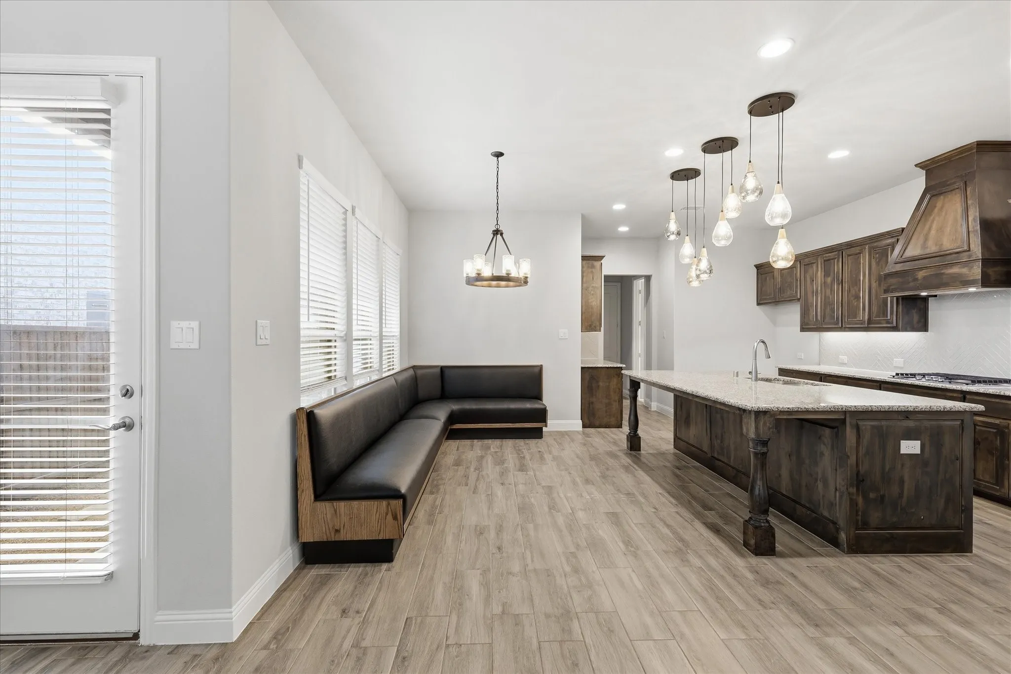Spacious kitchen and dining area with wood-finish flooring