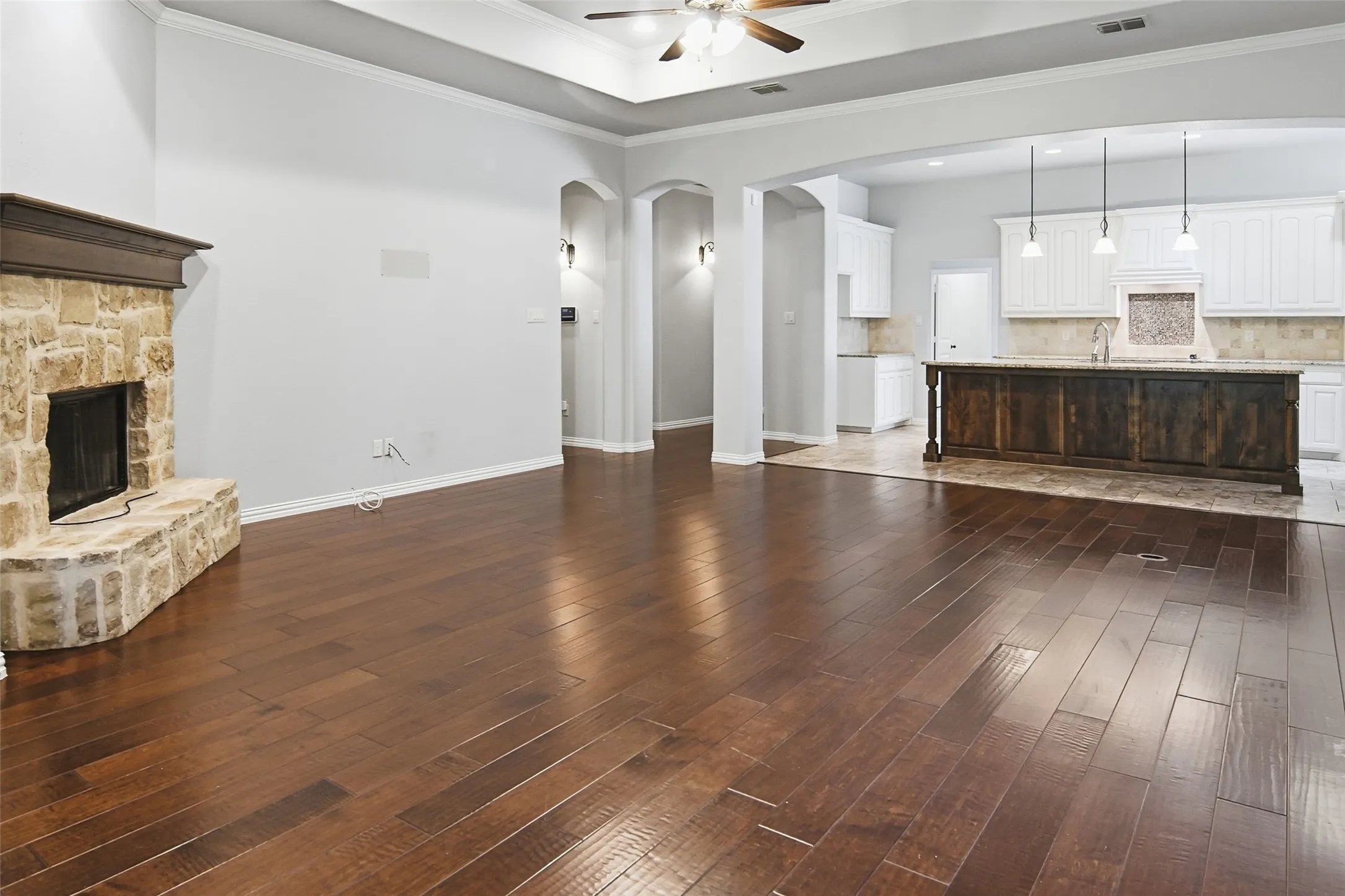 crown molding, wood floors, stone fireplace, amazing kitchen
