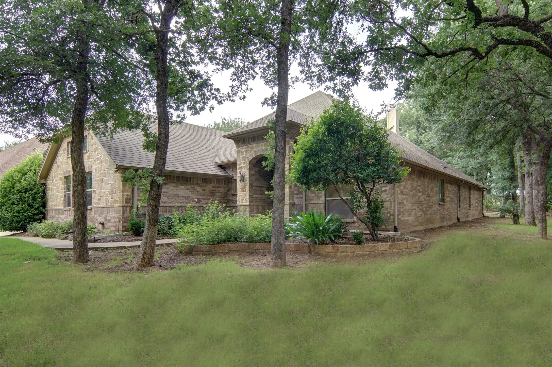 Beautifully landscaped with amazing trees.