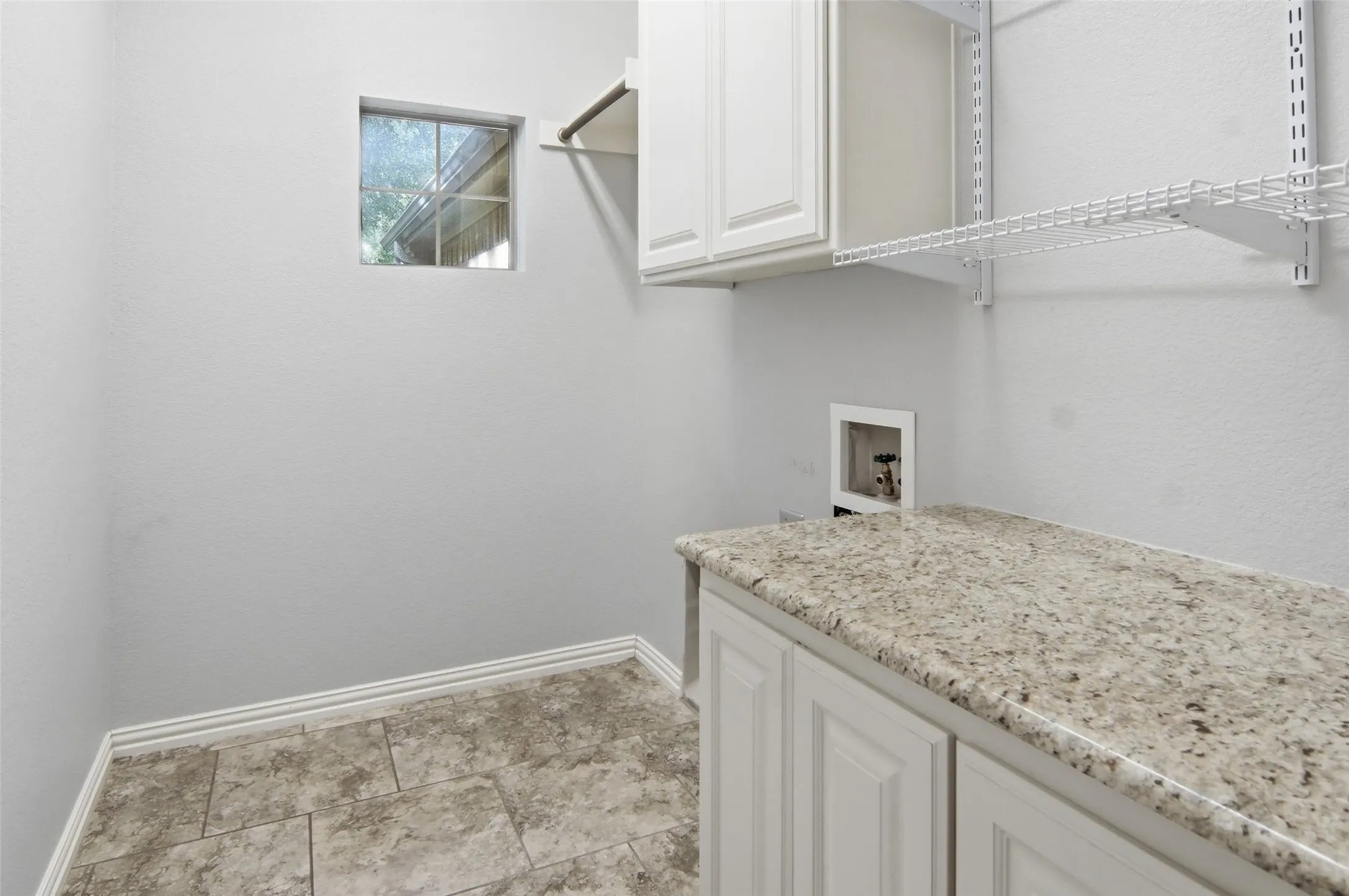 Utility room, drip dry area, granite counter, tile floor, room for a freezer