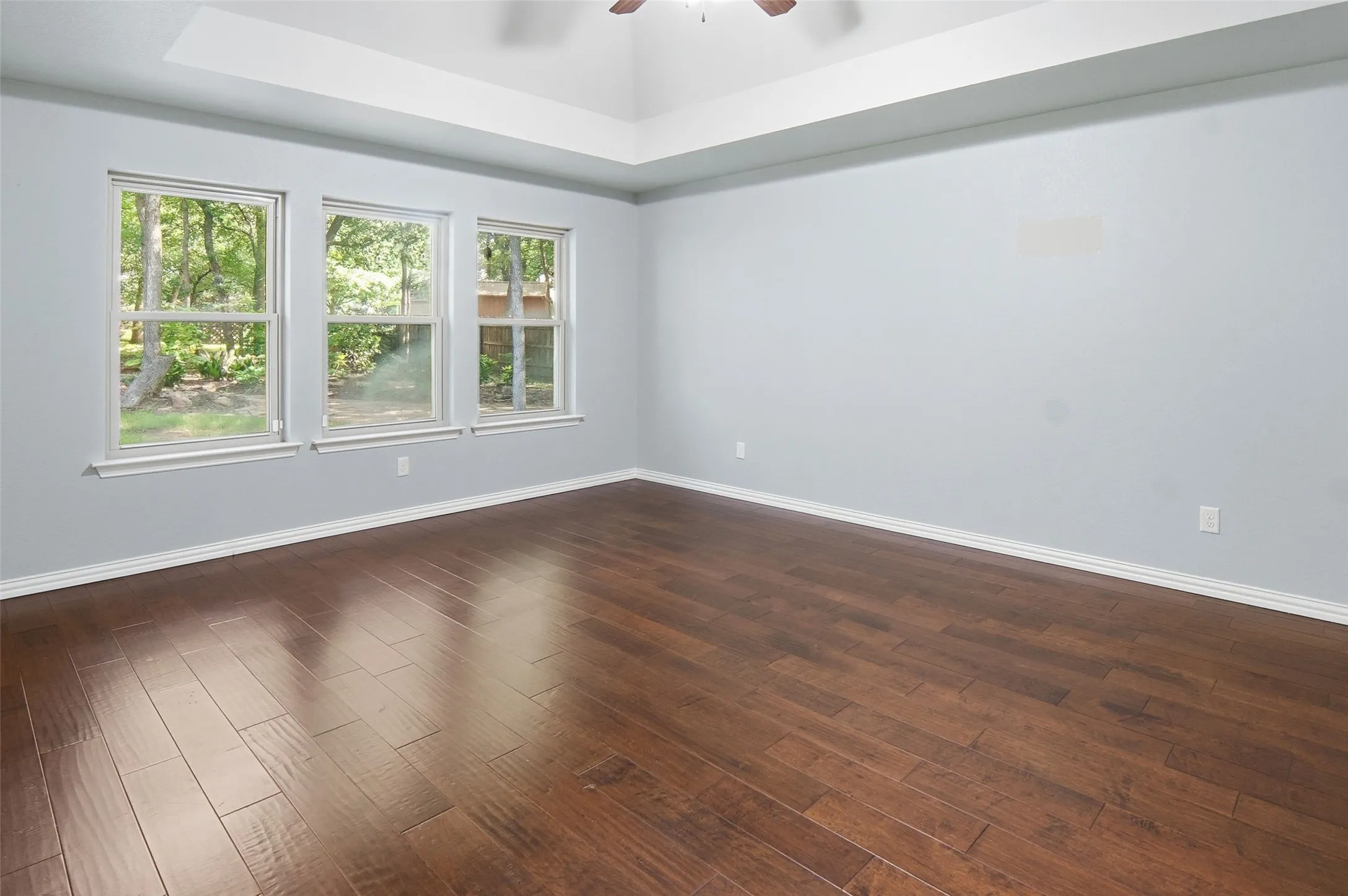 spacious game room with view of the lush backyard