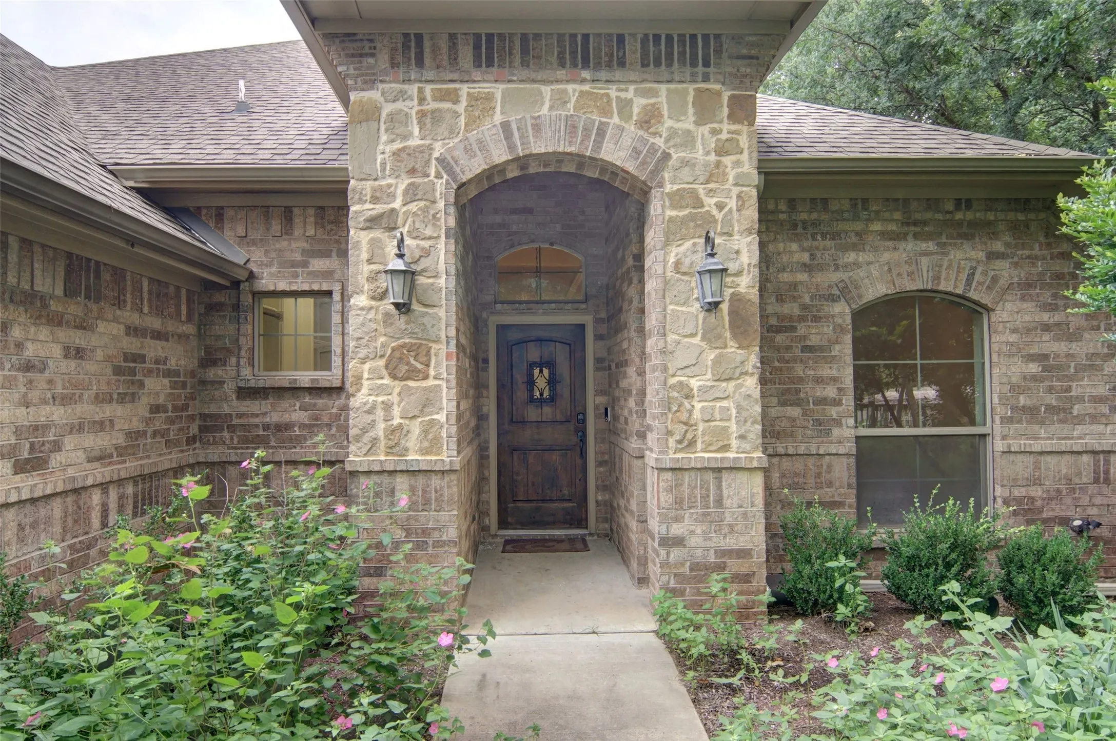 covered front porch with solid wood door for an inviting look