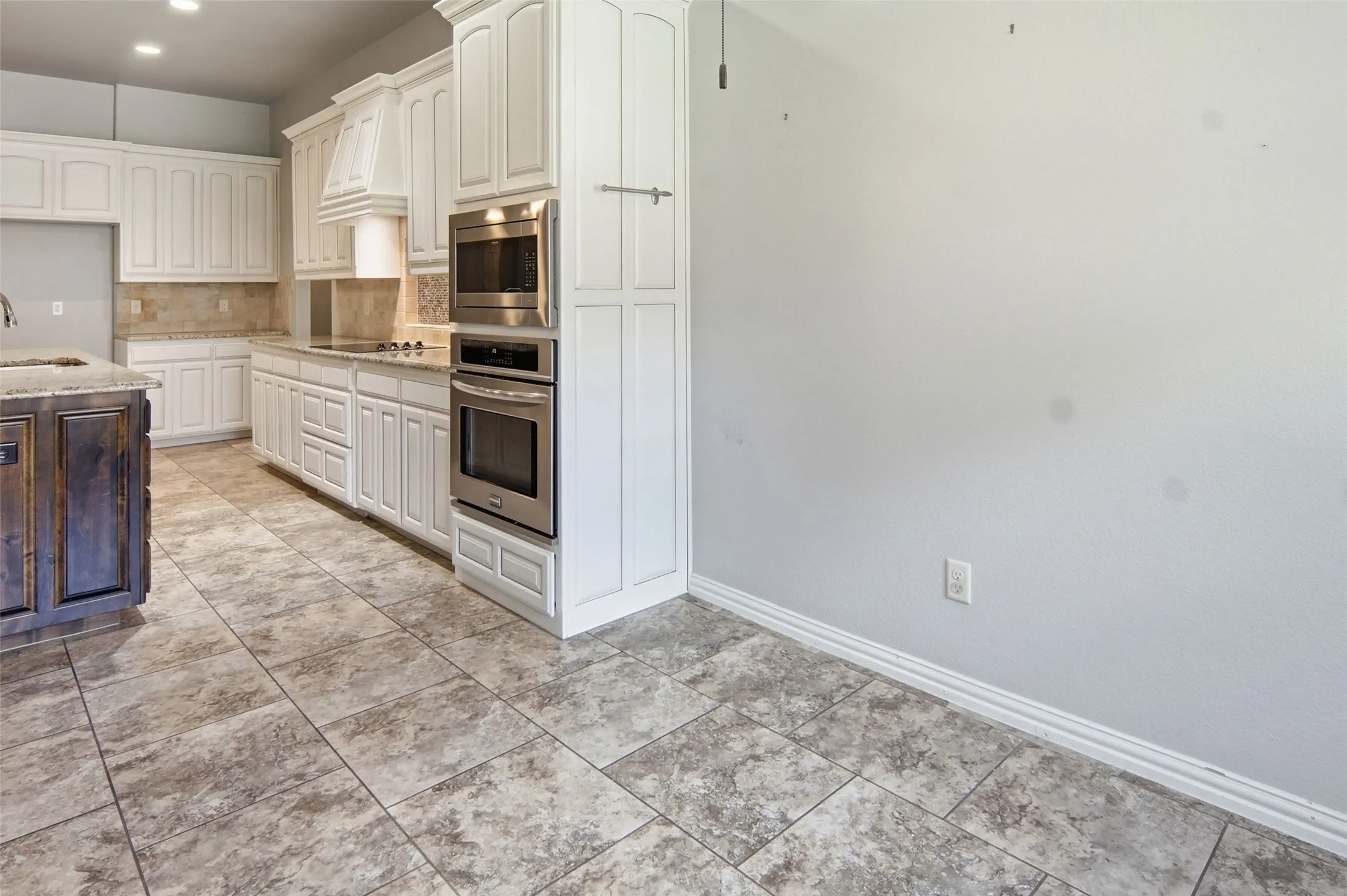 42 inch cabinets, granite top counter space, and electric cooktop