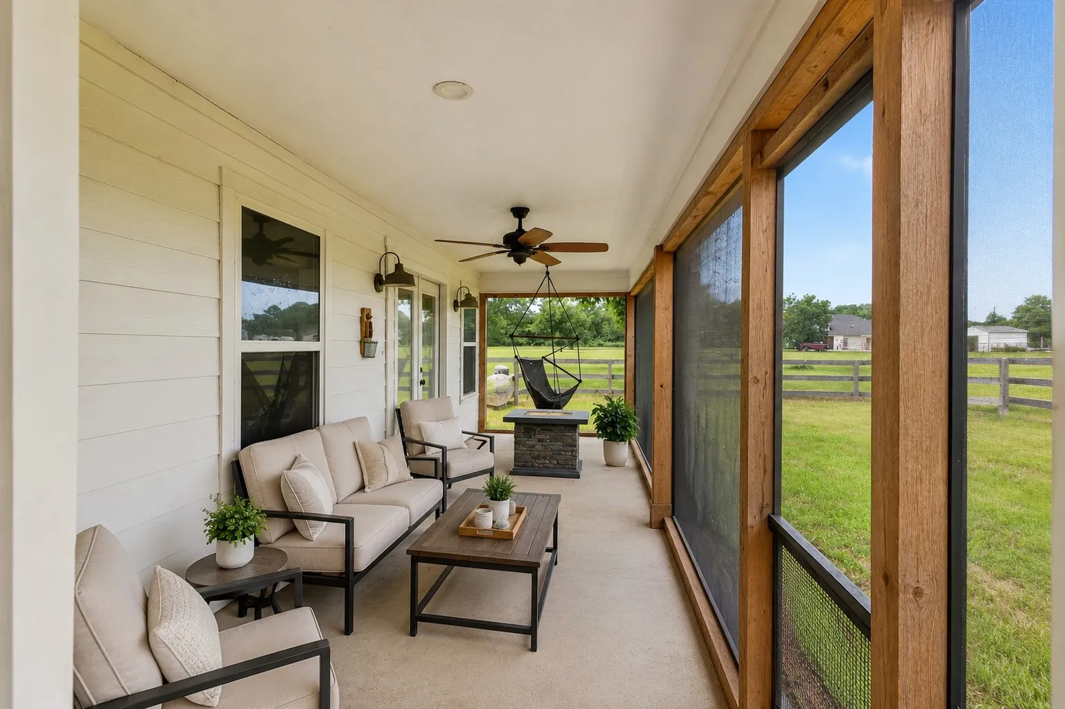 Expansive screened-in porch featuring a concrete floor, wood-look ceiling fan, and recessed lighting. Some elements are virtually staged.
