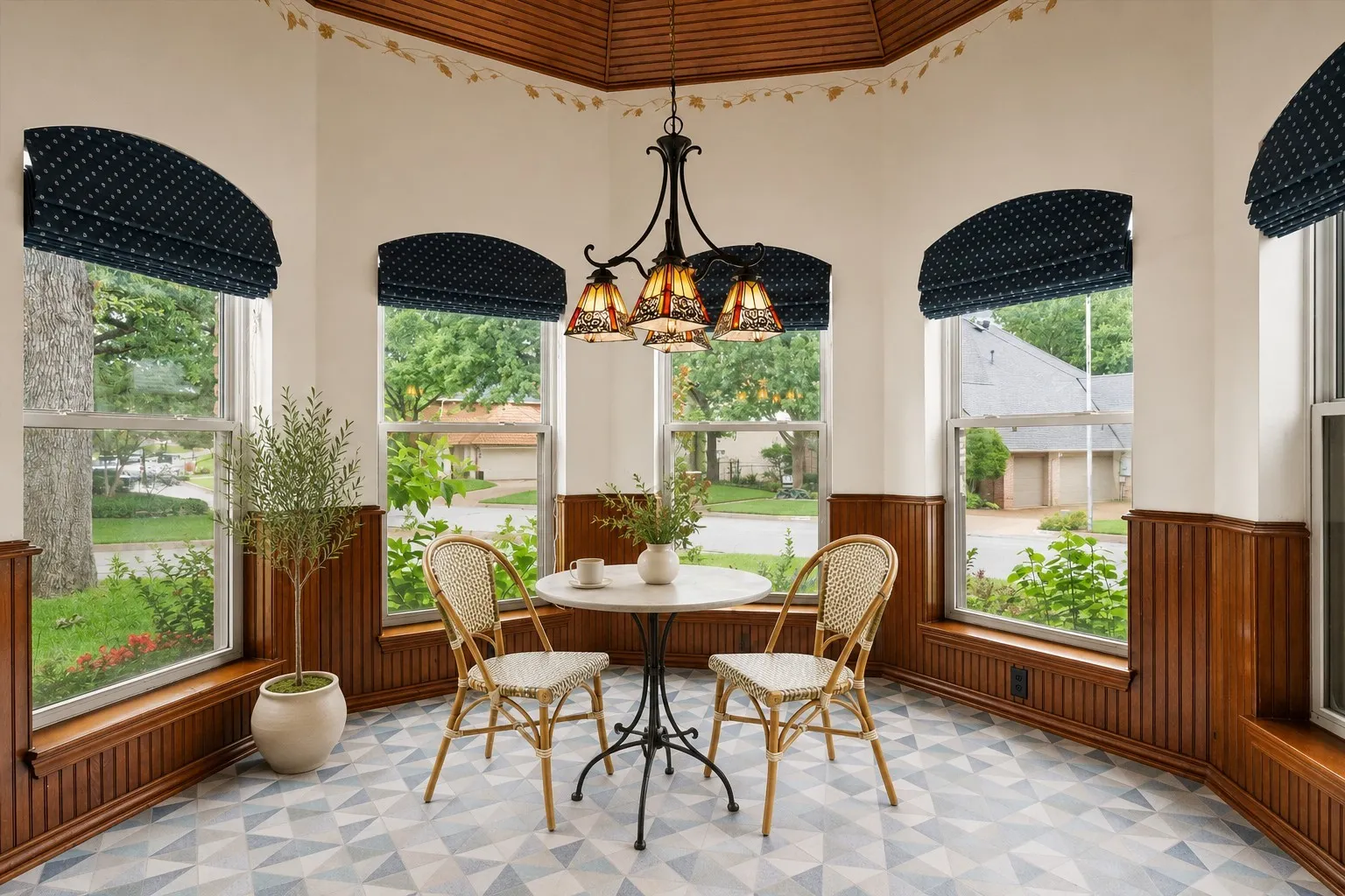 VIRTUALLY STAGED Bay window breakfast nook featuring a decorative ceiling, wood paneling, and an overhead pendant light fixture