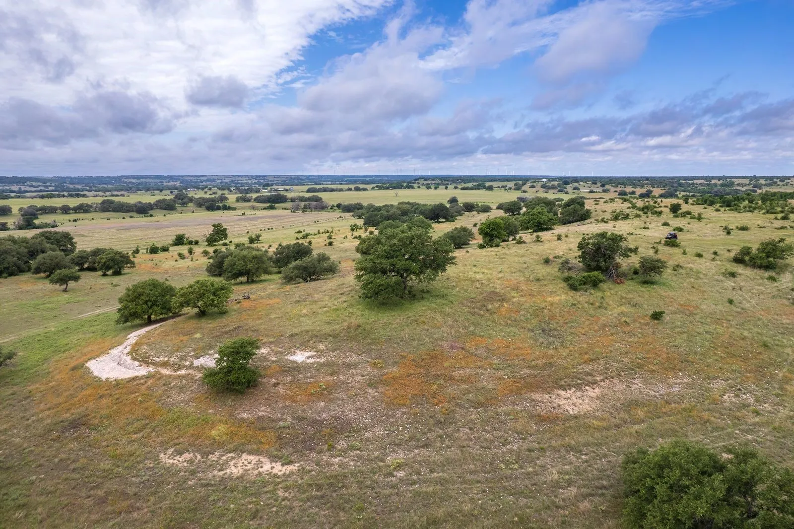 Expansive acreage featuring rolling terrain and scattered mature trees