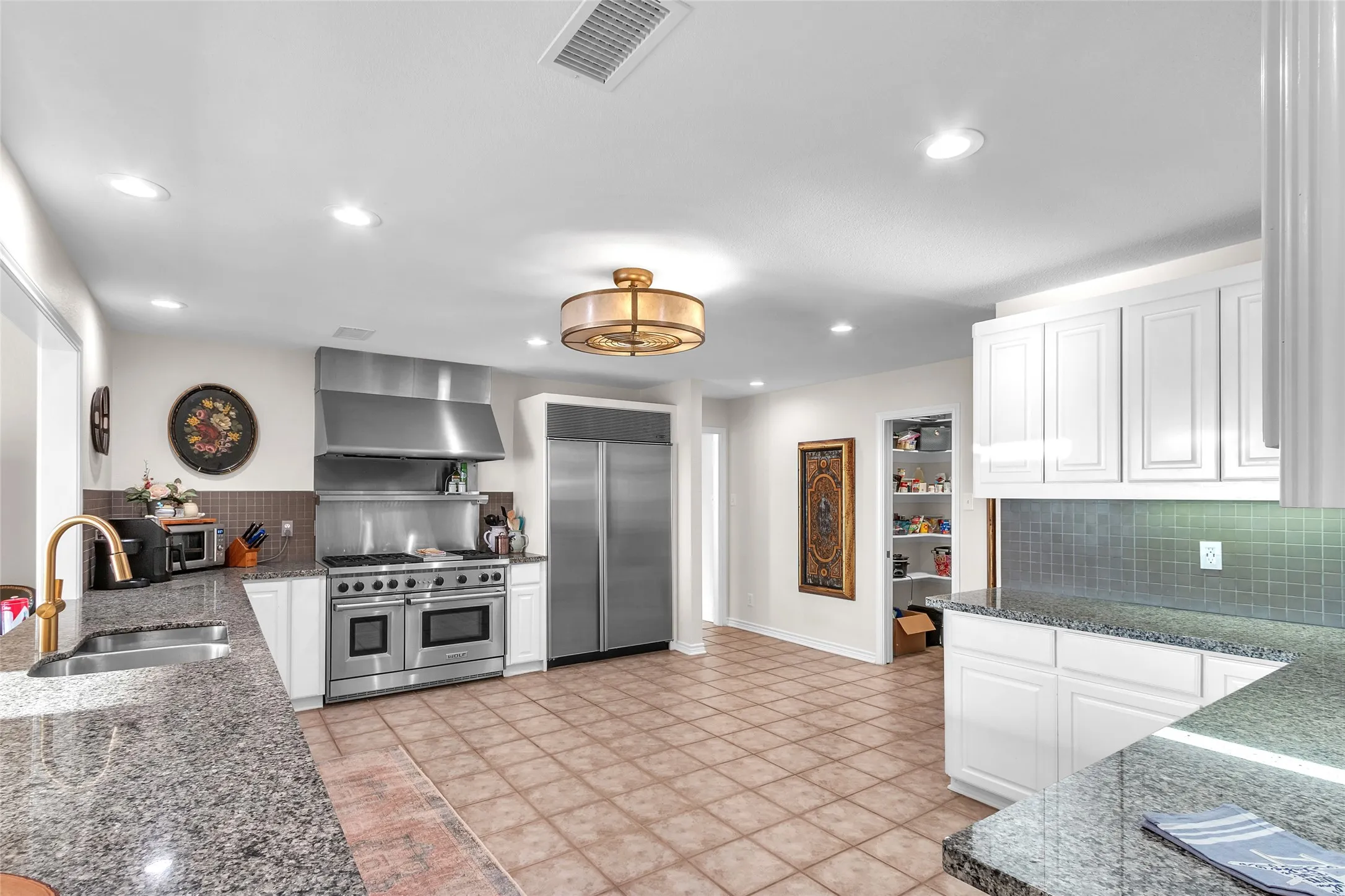 Gourmet Kitchen features lazy susans in all corners, slide-outs in lower cabinets and granite countertops galore