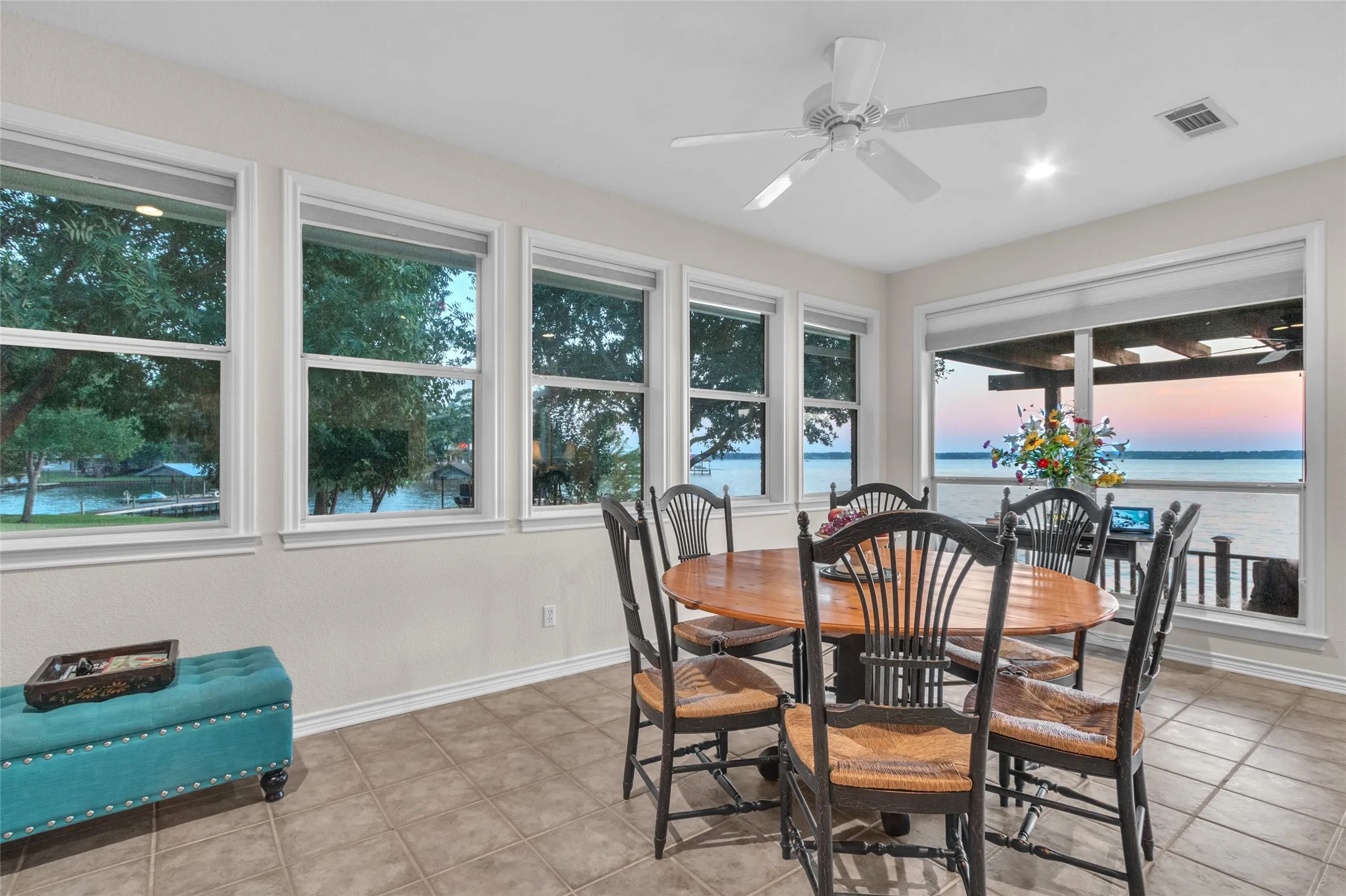 Second dining area or game table surrounded by vibrant water views