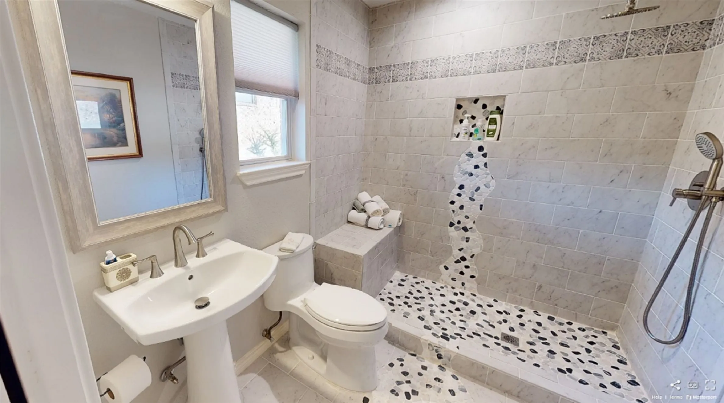 Bathroom 2 with tiled shower, toilet, and tile patterned flooring