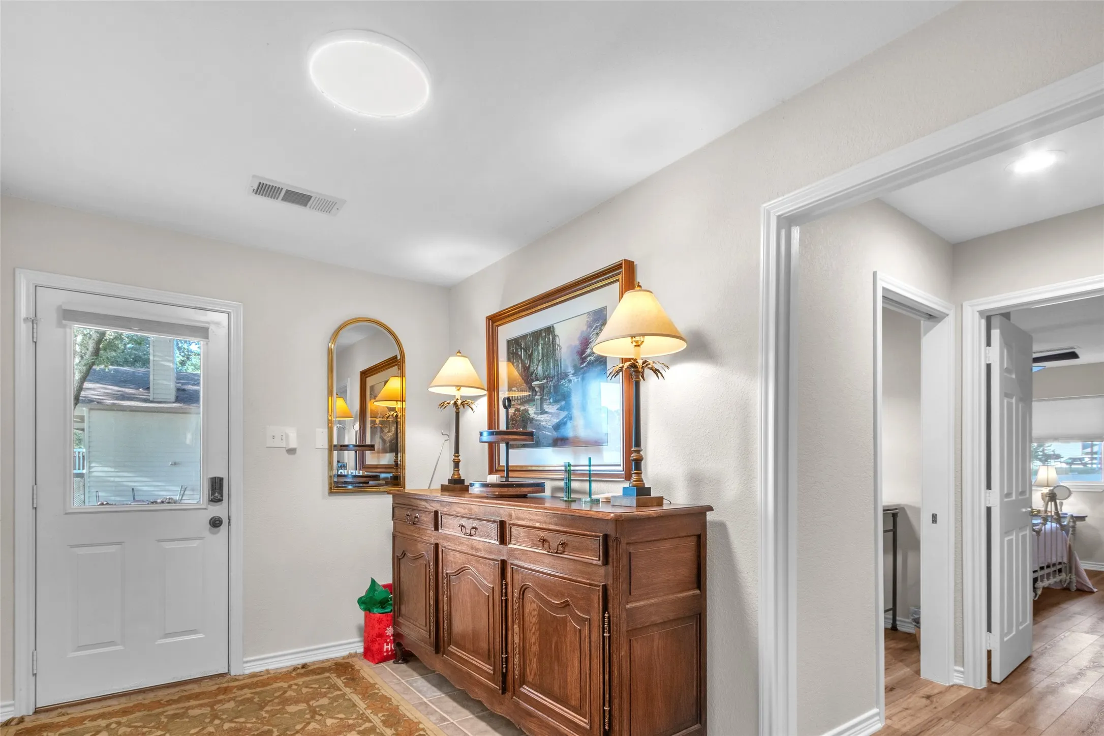Back Entryway is spacious with room for seating, storage and towels, coats, etc. Laundry room is 1st door on left of this pic
