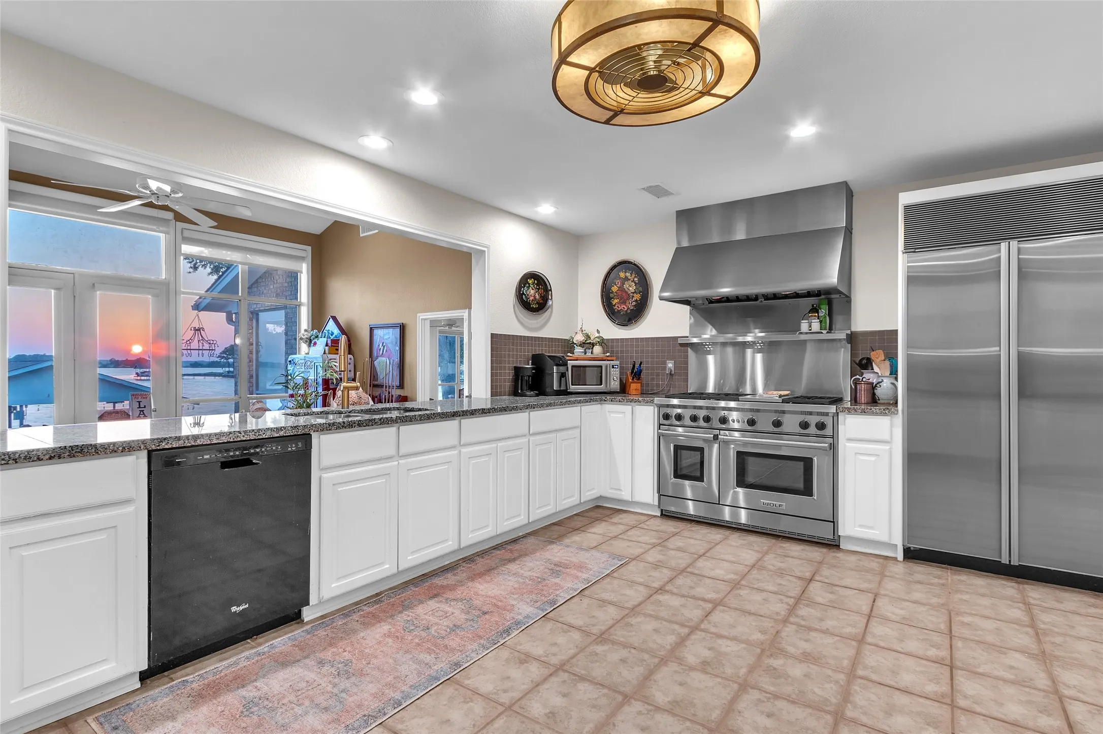 Gourmet Kitchen with LED can lighting, enclosed fan-light, top of the line appliances, yards of granite countertops...a fabulous gourmet kitchen
