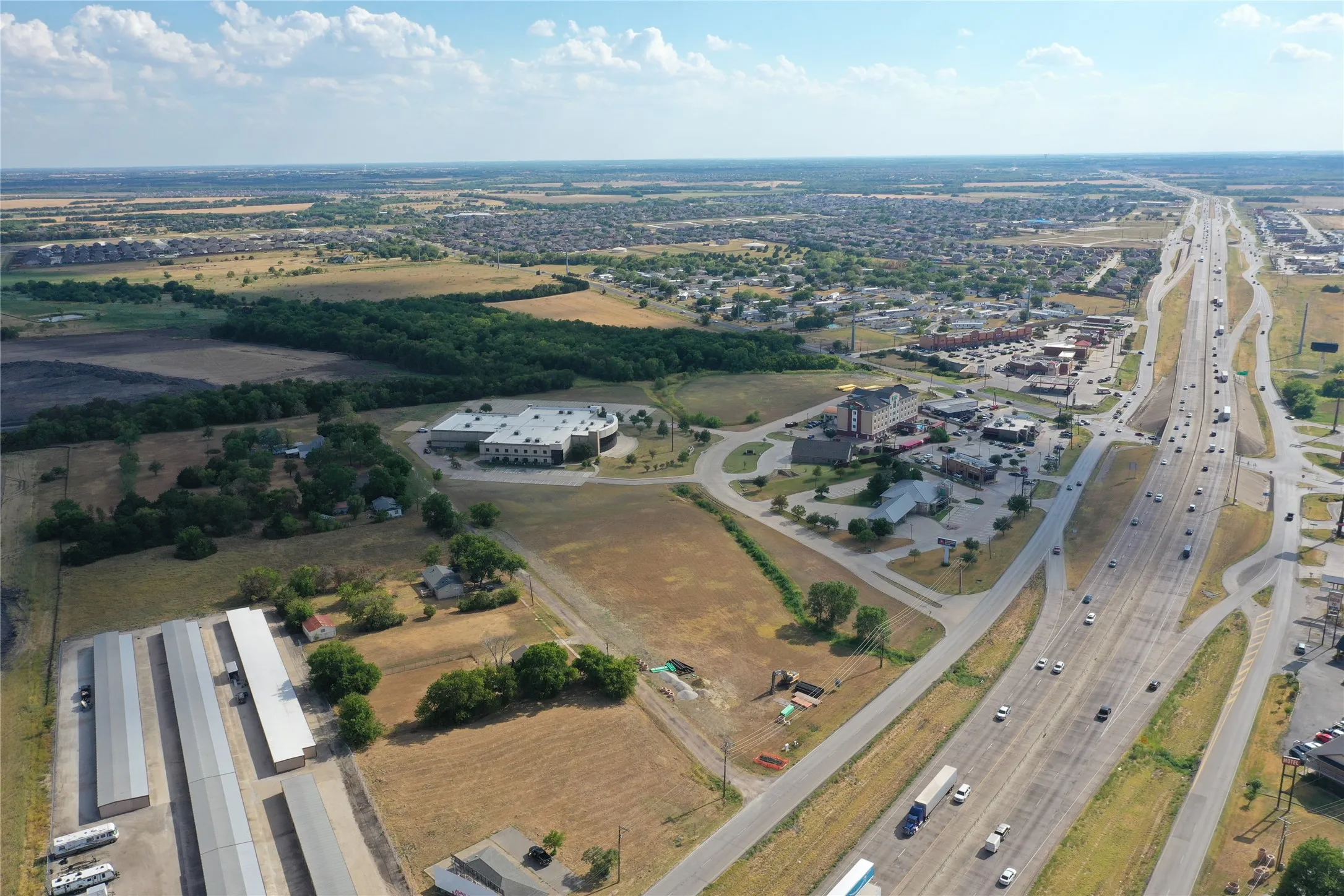 Aerial overview showcasing expansive open land with commercial development opportunities