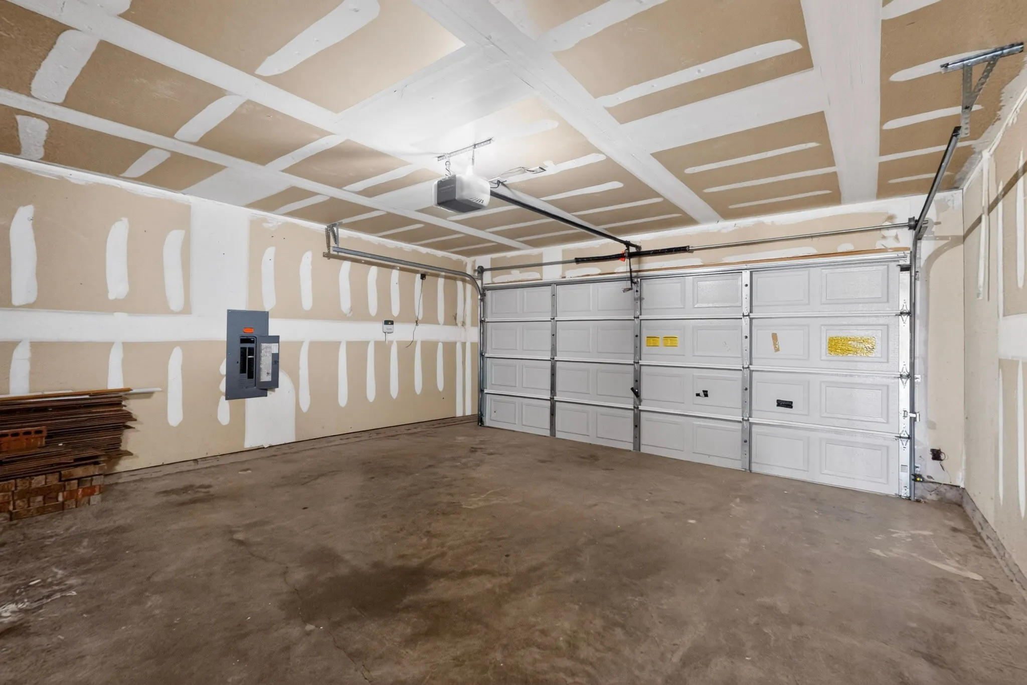 Spacious garage featuring a concrete floor, a sectional garage door, and an overhead garage door opener