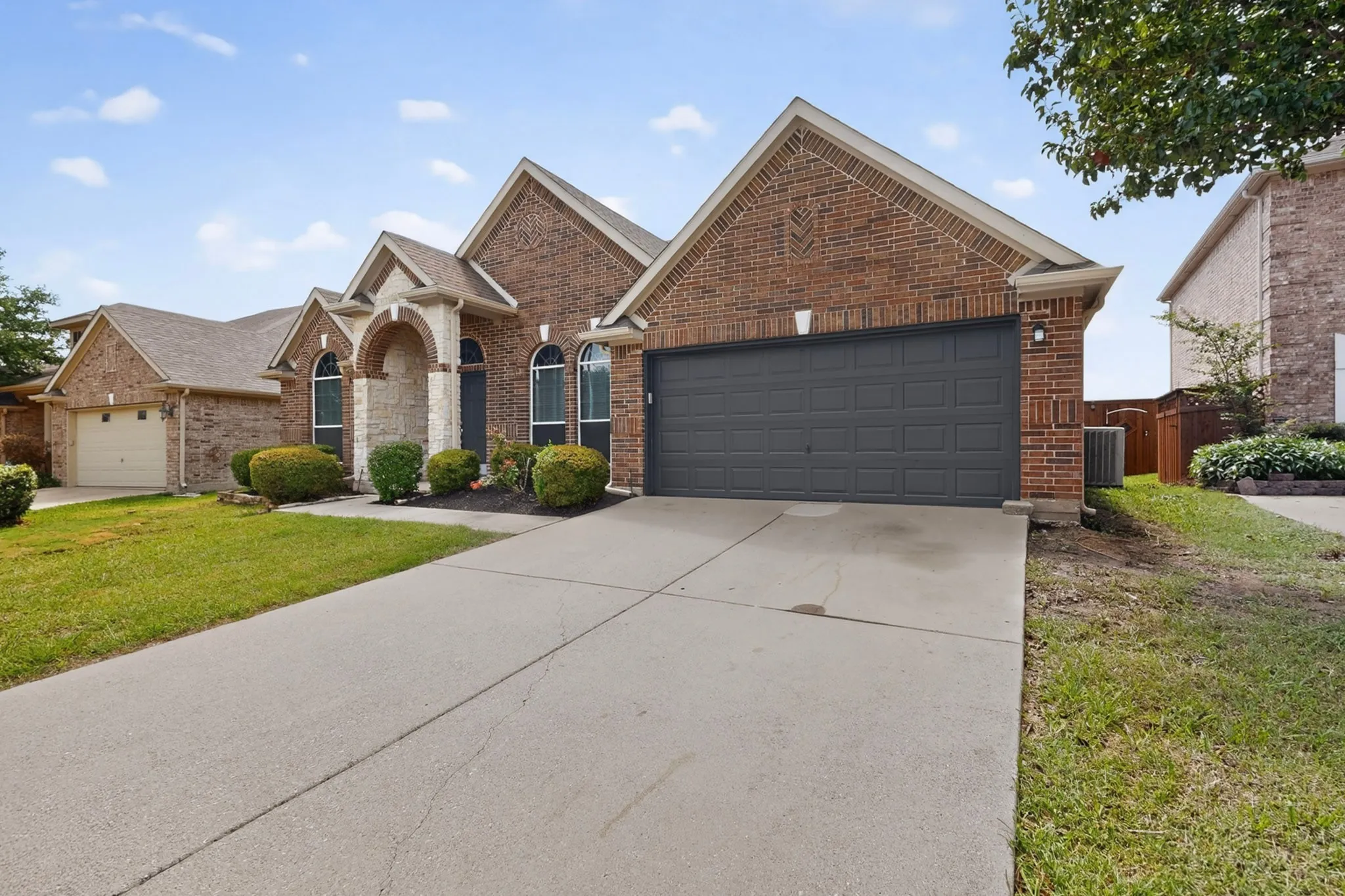 Brick exterior featuring stone accents and arched window details