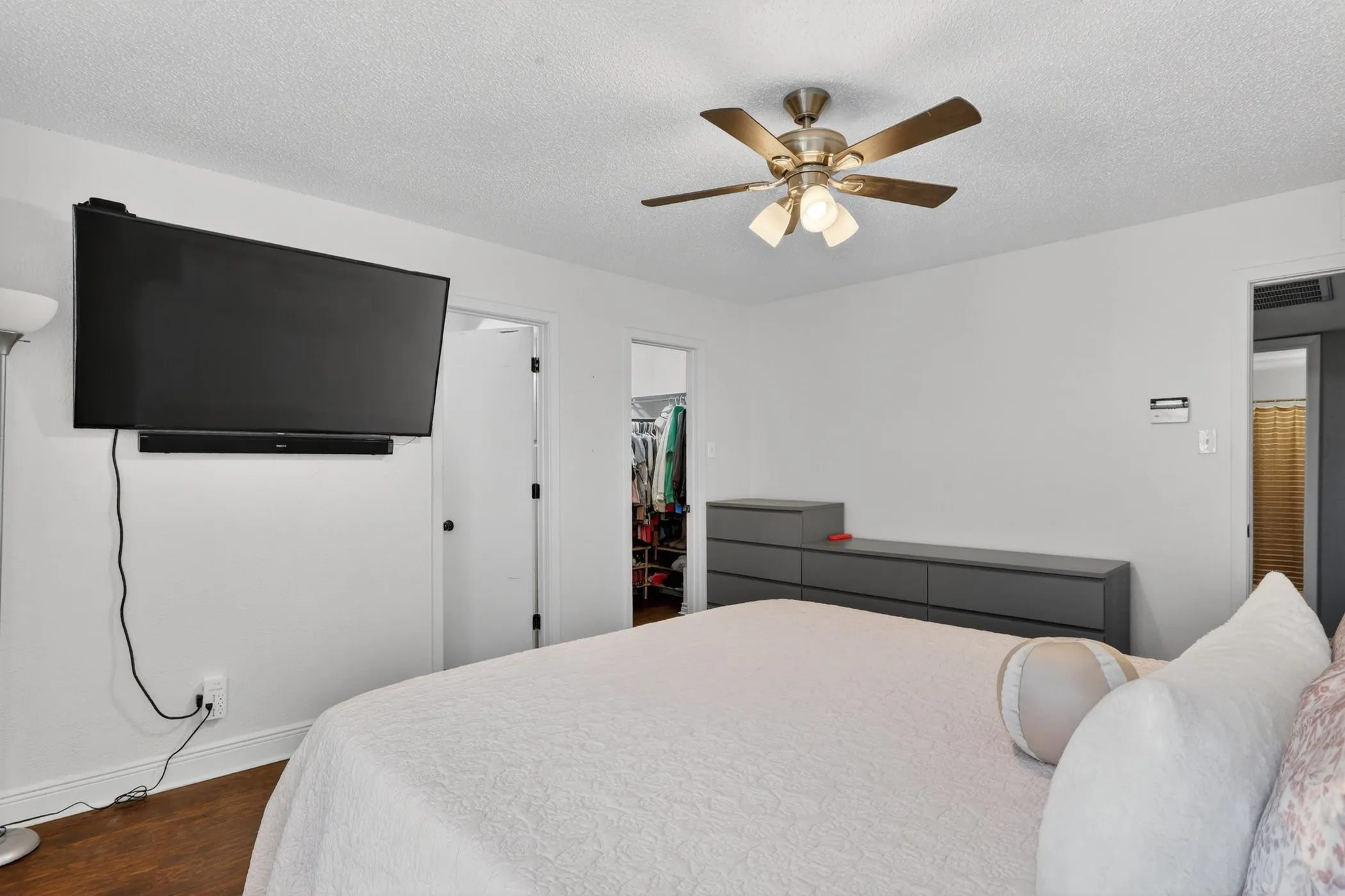 Recessed lighting, wood-finish flooring, and white walls