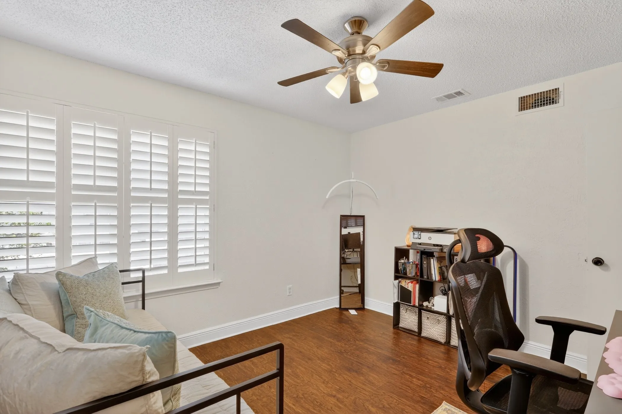 Interior space featuring wood-finish flooring, white baseboards, and light-toned walls