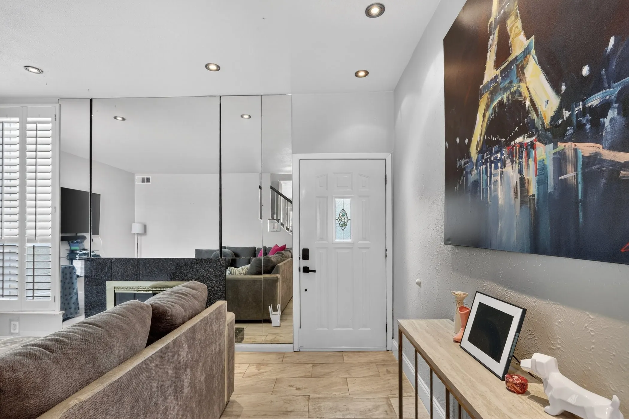 Entryway featuring wood-finish flooring, recessed lighting, and a white paneled door with decorative glass inlay