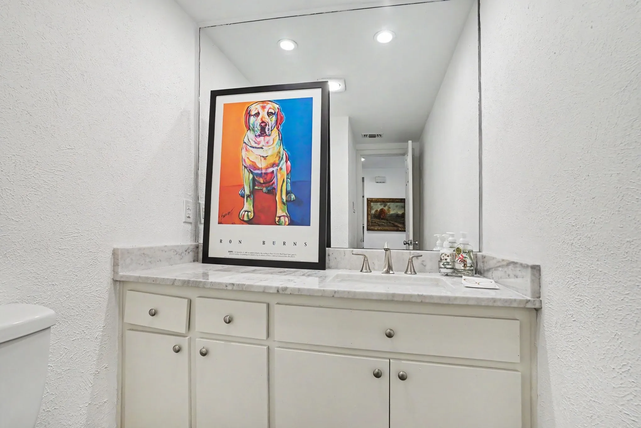 Vanity with a light-toned countertop, 1/2 bath, undermount sink, and brushed nickel faucet hardware