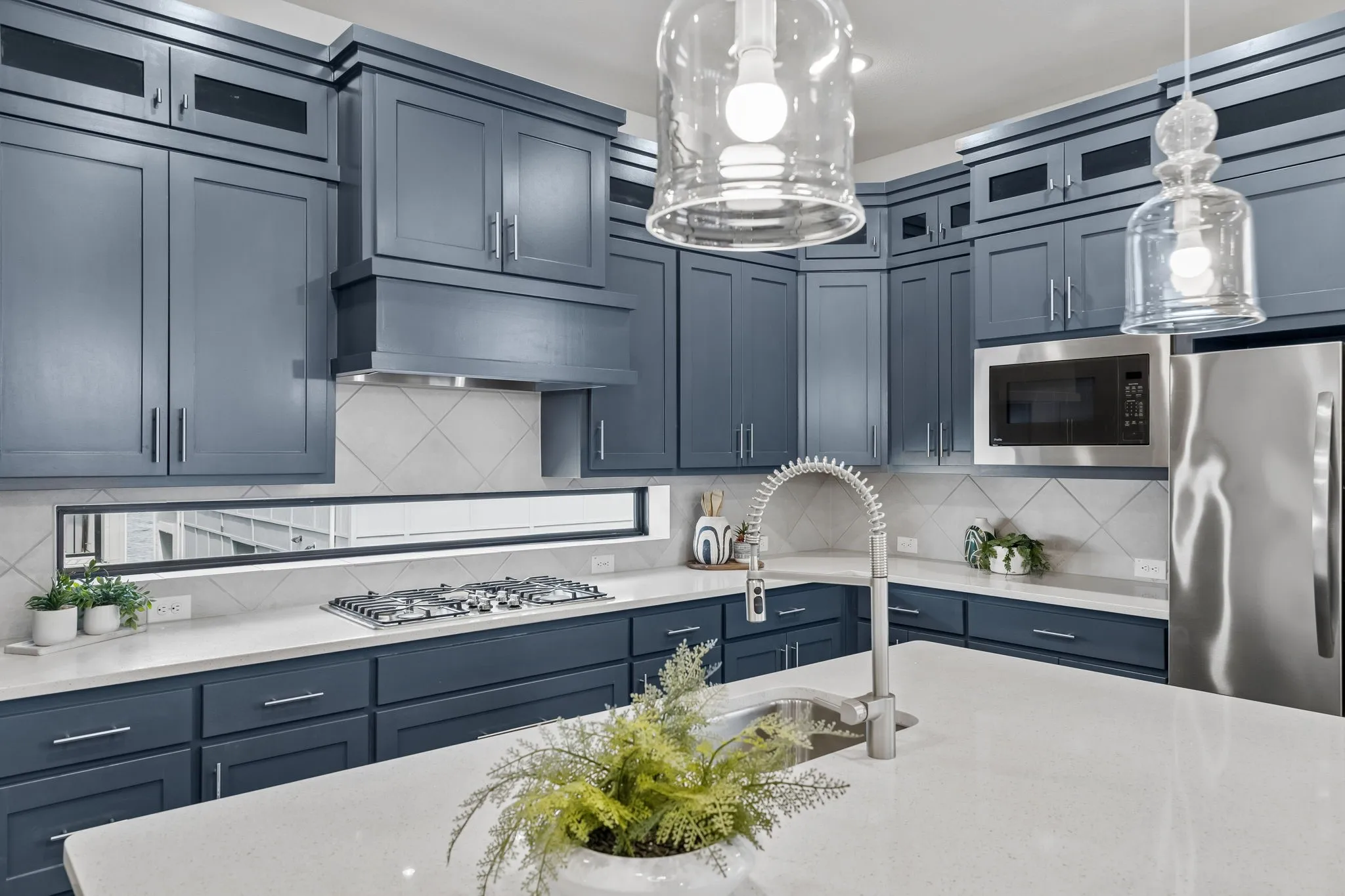 Designer Kitchen with Custom Appeal
Striking cabinetry, quartz countertops, stainless appliances, and an oversized island combine beauty and functionality for everyday cooking and entertaining.