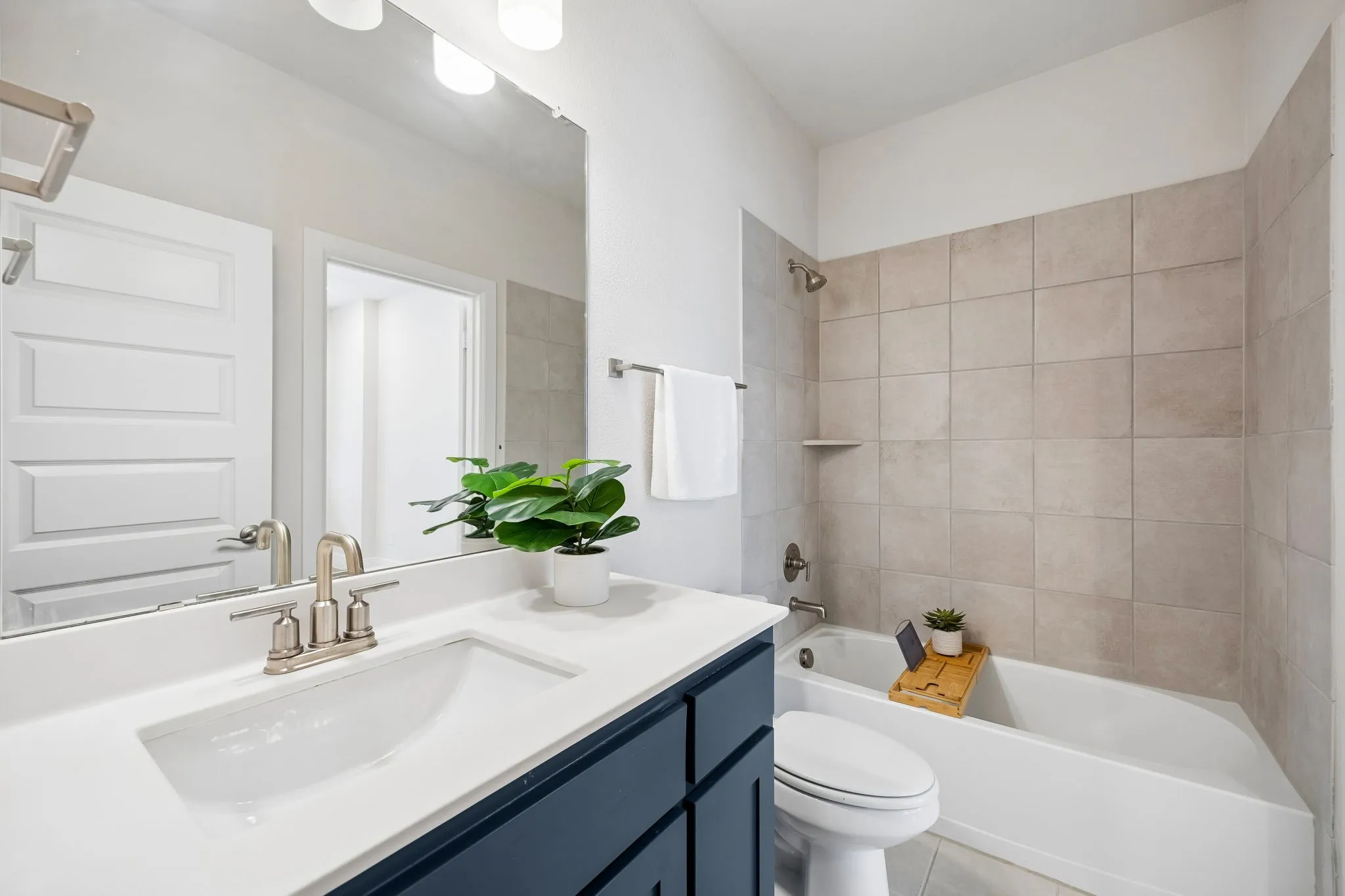 Stylish Full Bath
Clean-lined cabinetry, solid-surface counters, and a tiled tub-shower surround deliver both style and everyday practicality.