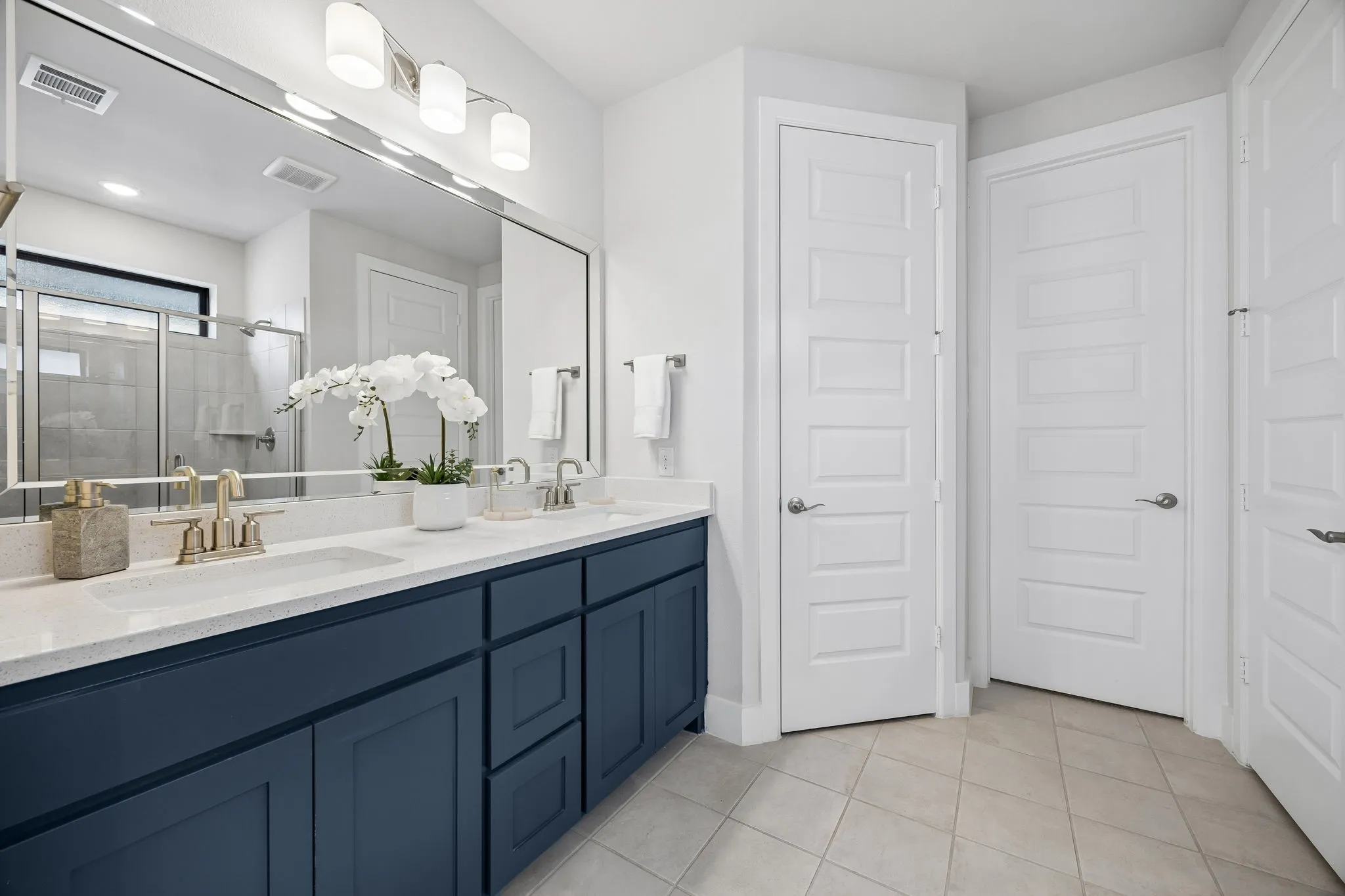 Spa-Inspired Primary Bath
Dual vanities, expansive counter space, and a large walk-in shower create a functional and refreshing daily routine.