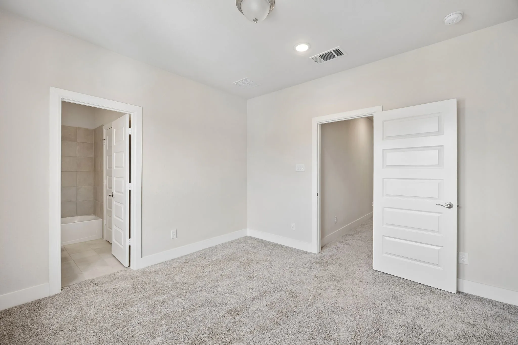 Well-Appointed Secondary Bedroom & Bath
Bright windows, a spacious layout, and an adjacent full bath provide comfort, convenience, and privacy.