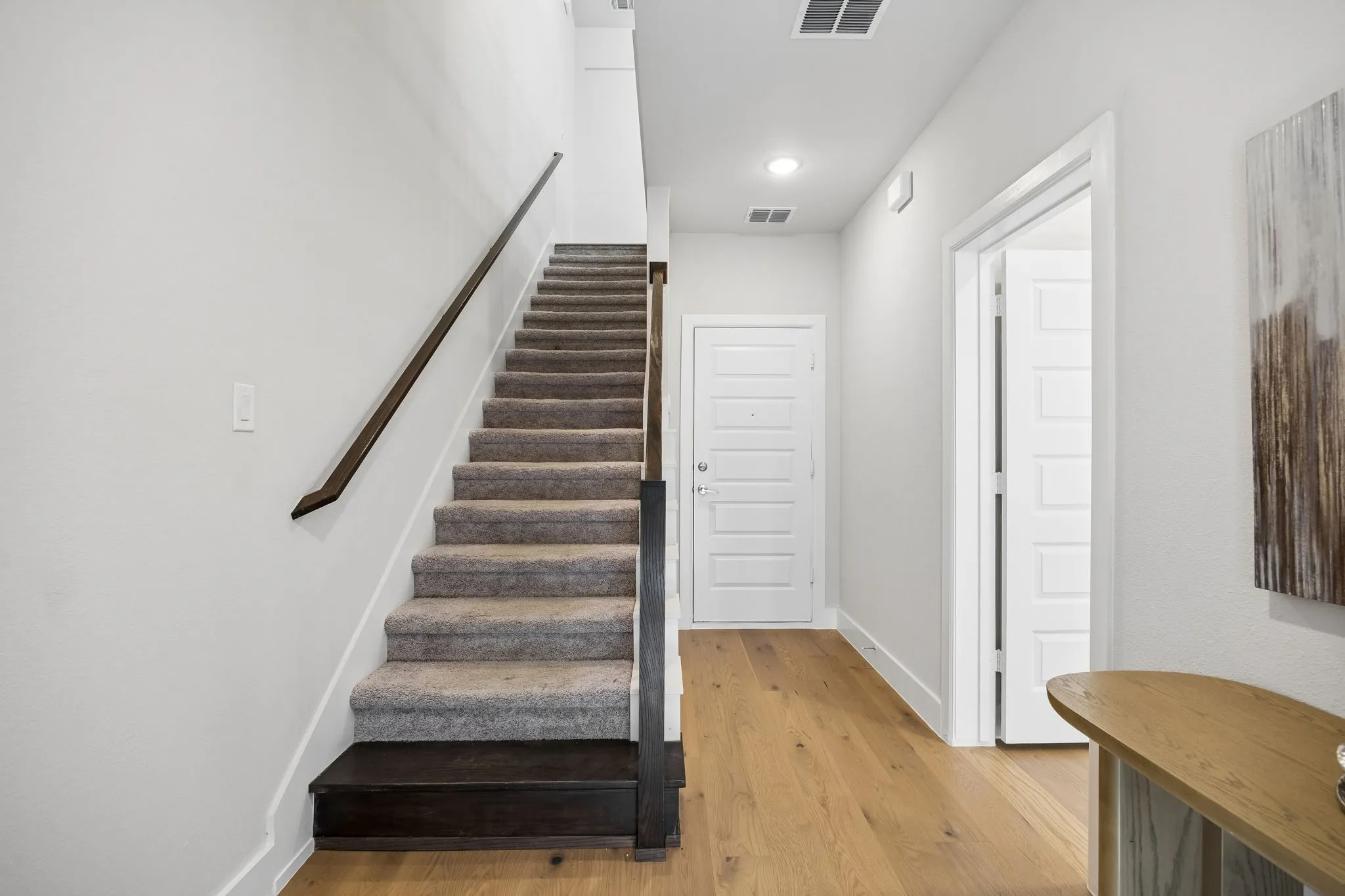 A Bright and Inviting Arrival
Wide-plank wood flooring, crisp finishes, and an open stair design set the tone for the stylish spaces that unfold throughout the home.