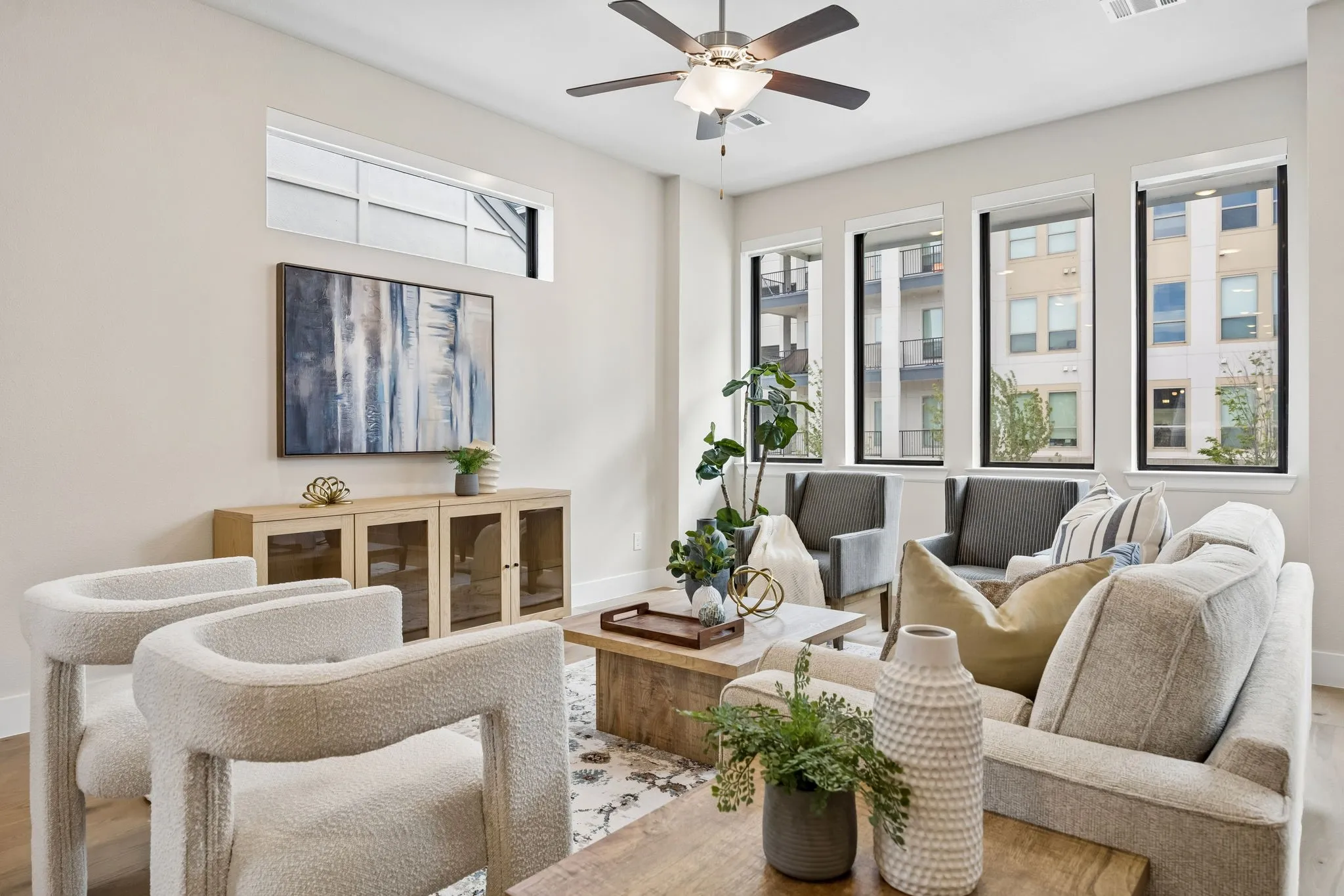 Inviting Family Room with Abundant Natural Light
Tall windows, soaring ceiling height, and an open layout create a bright and welcoming space designed for everyday living and entertaining.