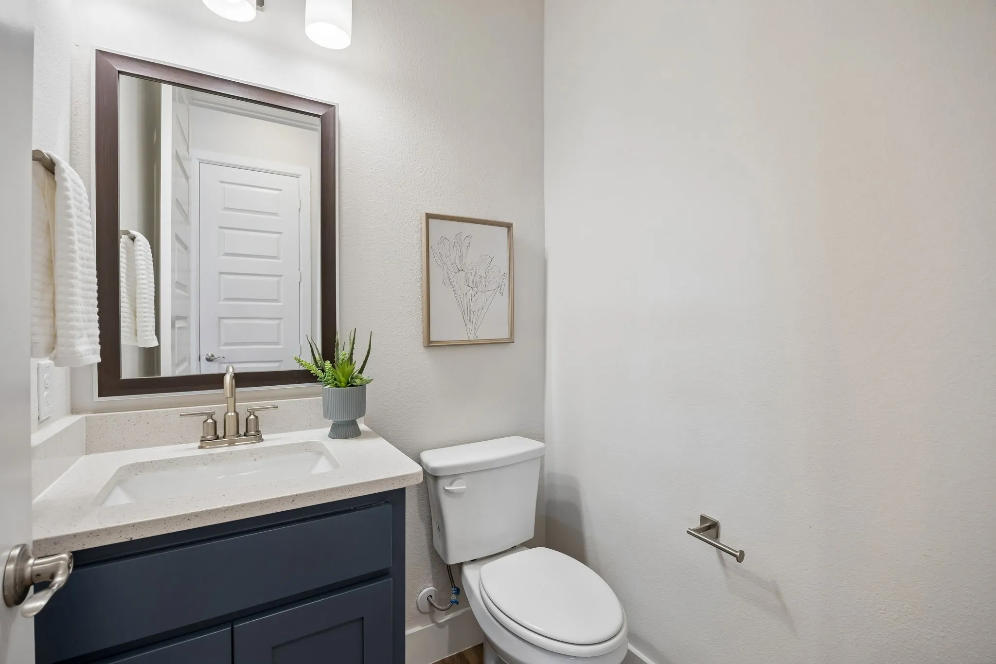 Convenient Powder Bath
A well-placed half bath serves the main living level with modern finishes and easy accessibility for guests.