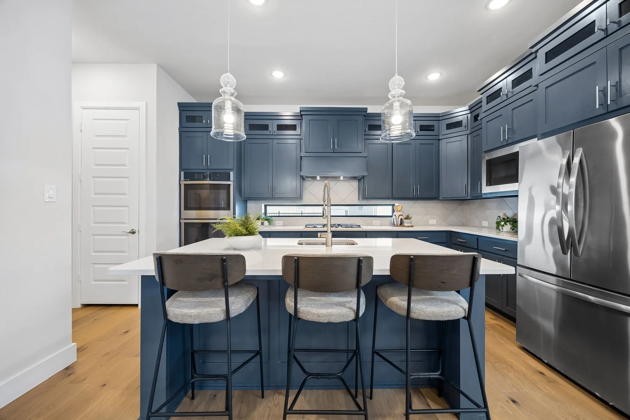 A Kitchen Designed to Impress
Rich cabinetry, expansive quartz surfaces, and a large center island combine style and functionality in this beautifully appointed kitchen.