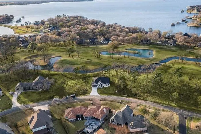 Expansive aerial perspective showcasing a residential community bordering a large body of water