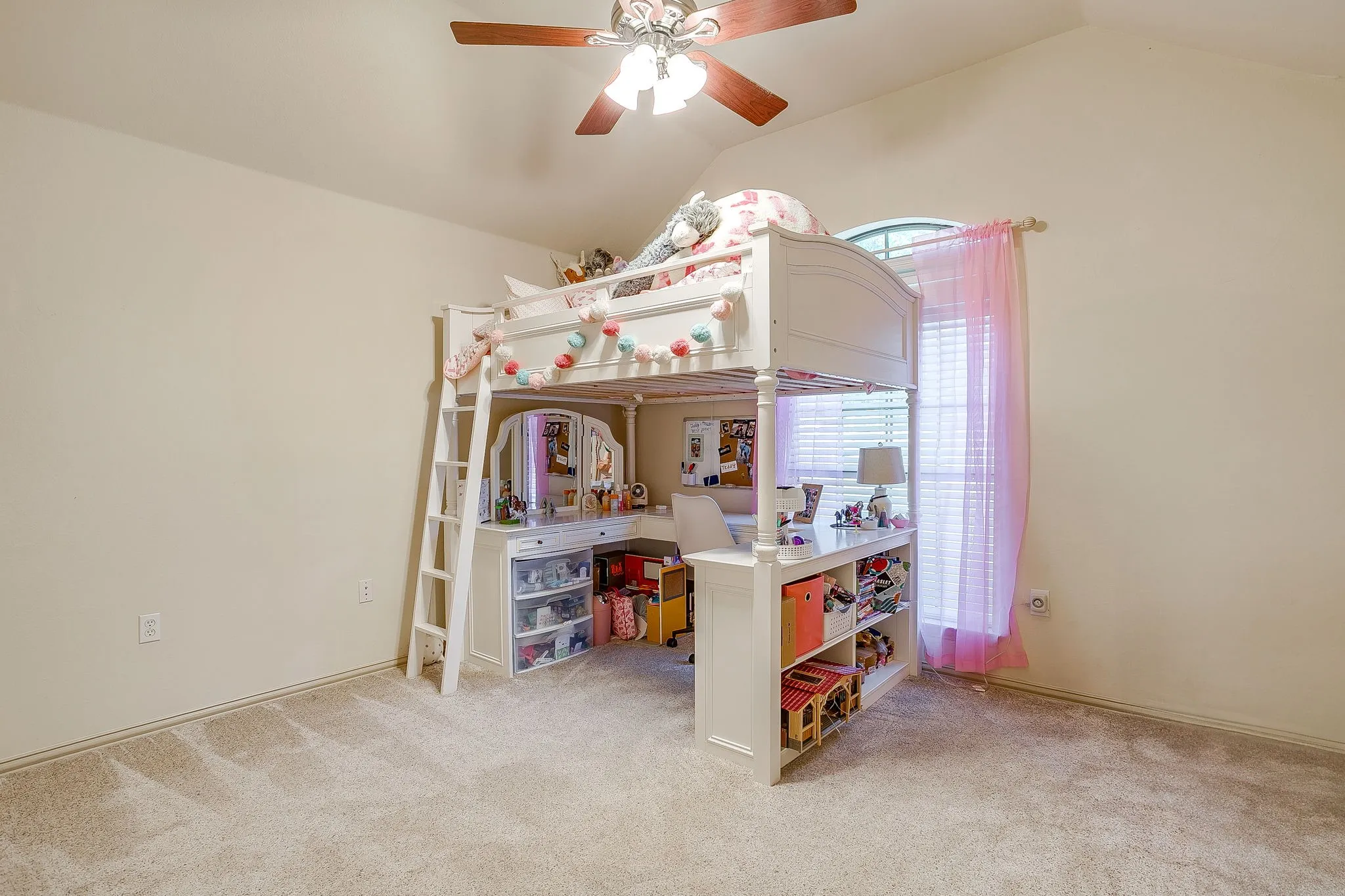 Vaulted ceiling with a ceiling fan, carpet flooring, and a large window with blinds