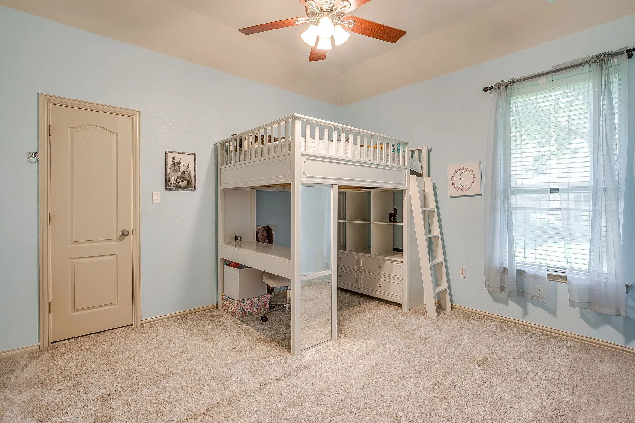 Textured carpeting, a single window with blinds, a ceiling fan with integrated lighting, and a neutral-toned door