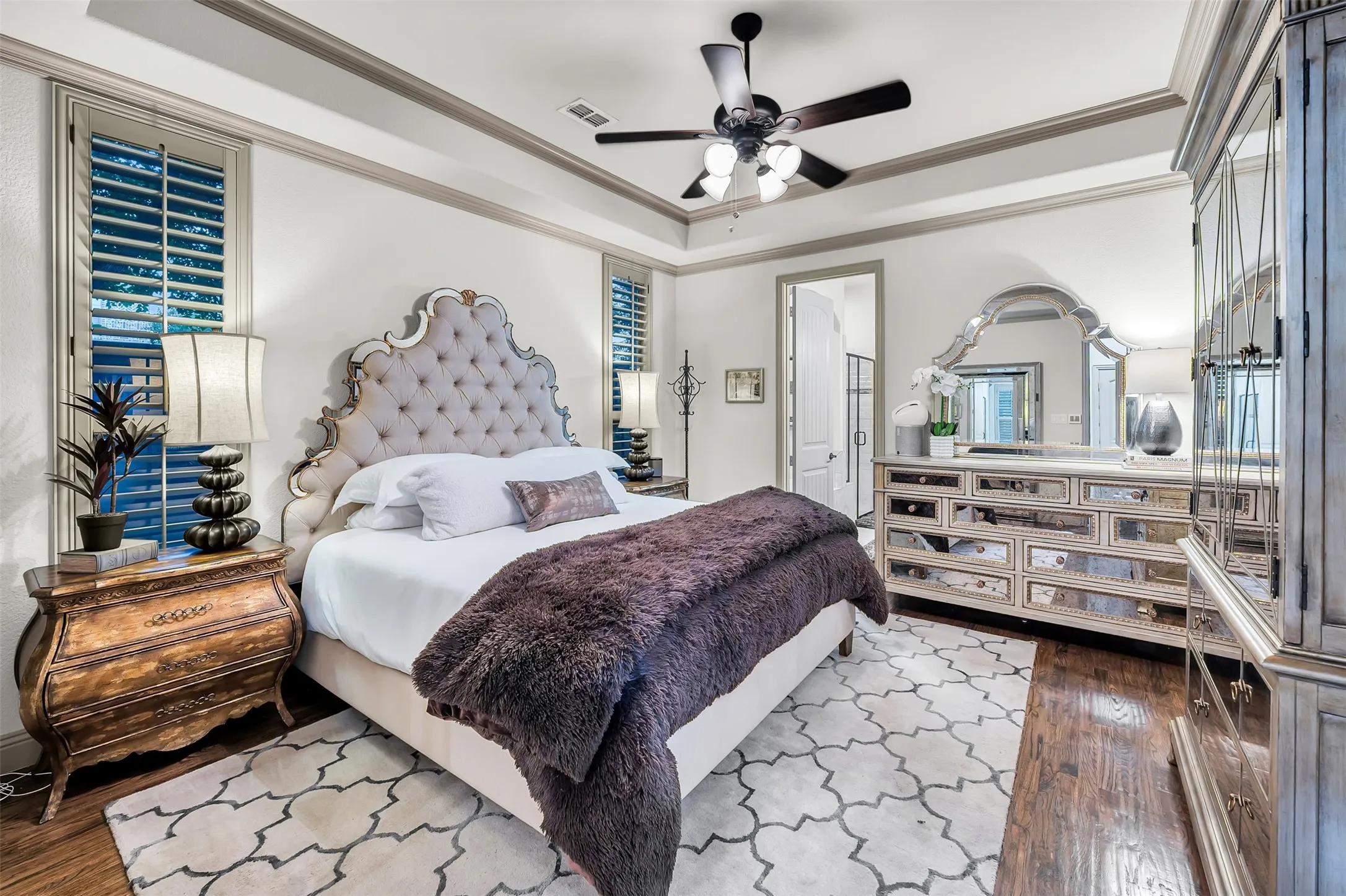 Recessed ceiling with crown molding, wood-finish flooring, and white wall paneling