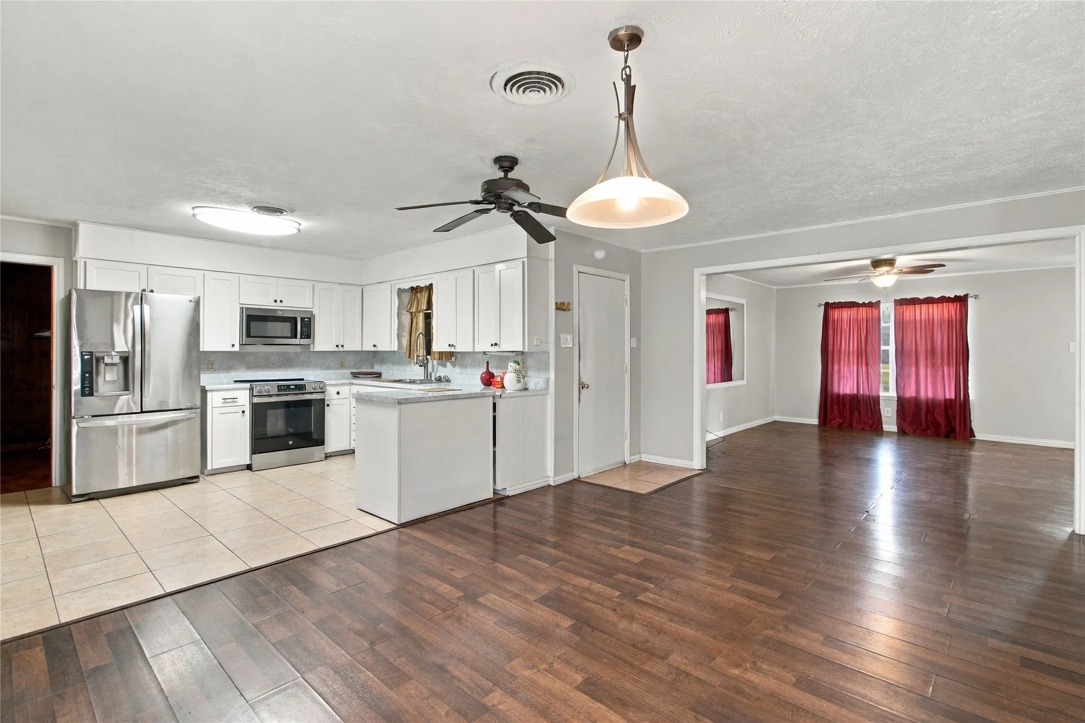Kitchen featuring white cabinetry, stainless steel appliances, and a tiled floor