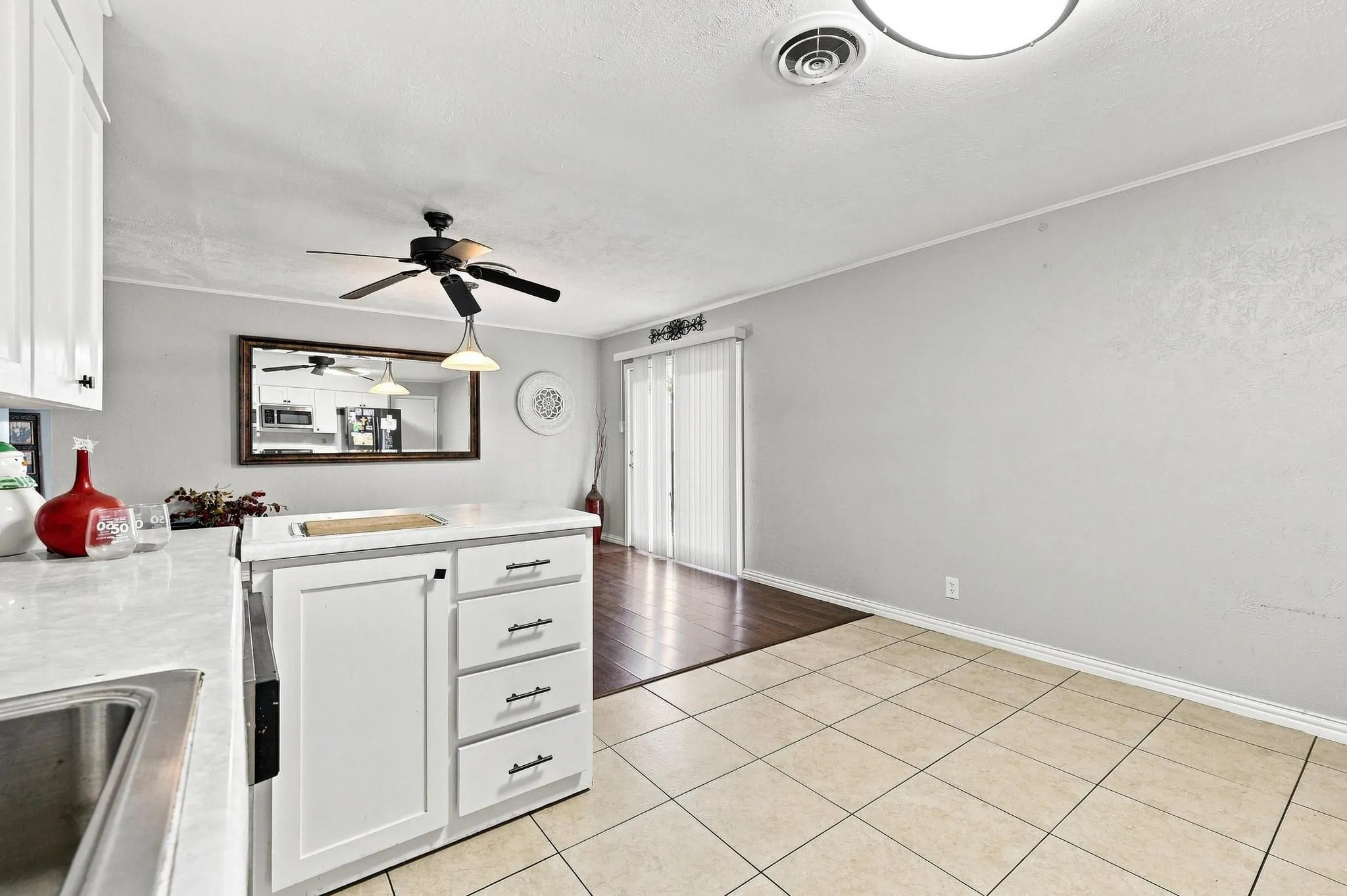 Kitchen featuring white cabinetry, a stainless steel sink, and a countertop