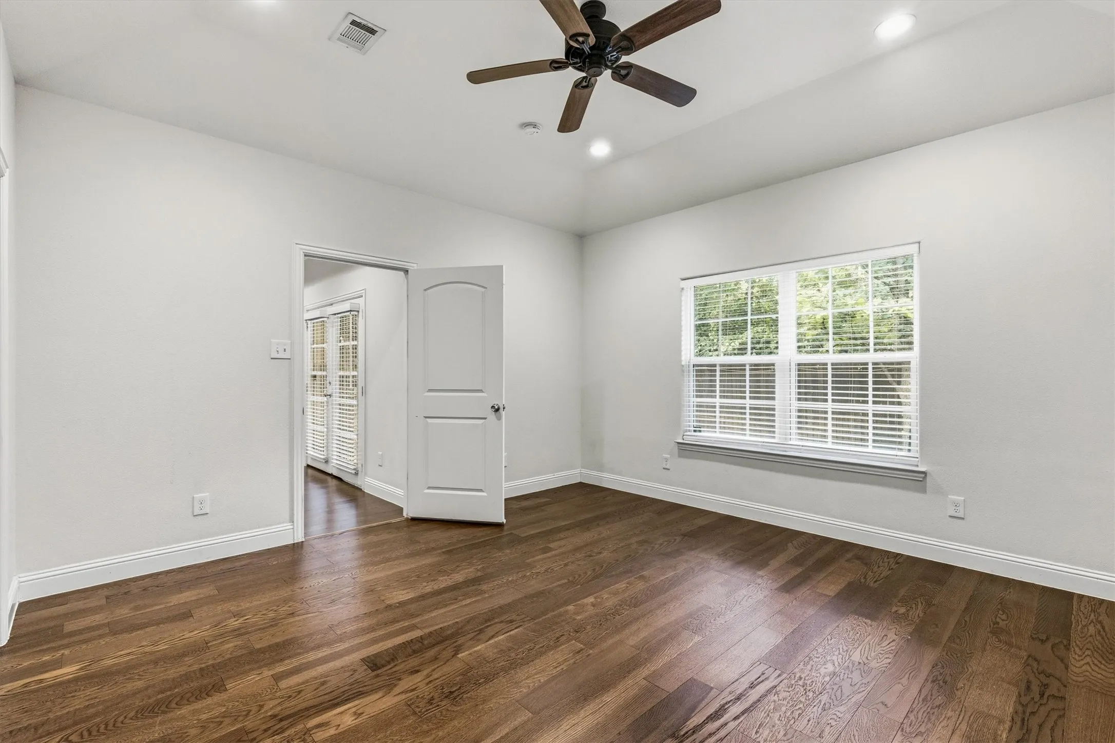 Wood-finish flooring, recessed lighting, and a ceiling fan