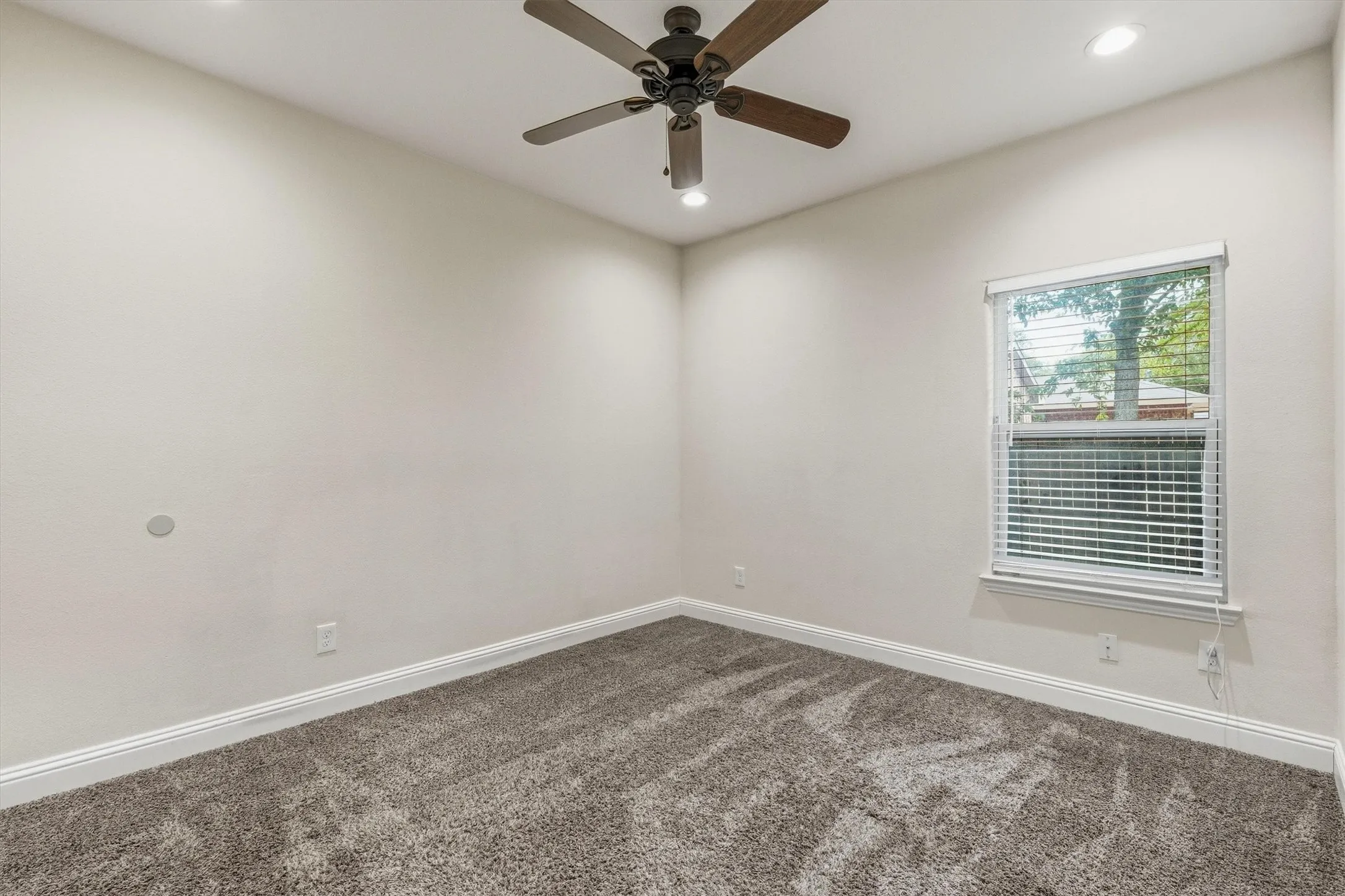 Recessed lighting, ceiling fan with light, plush carpet flooring, white window blinds, and white trim