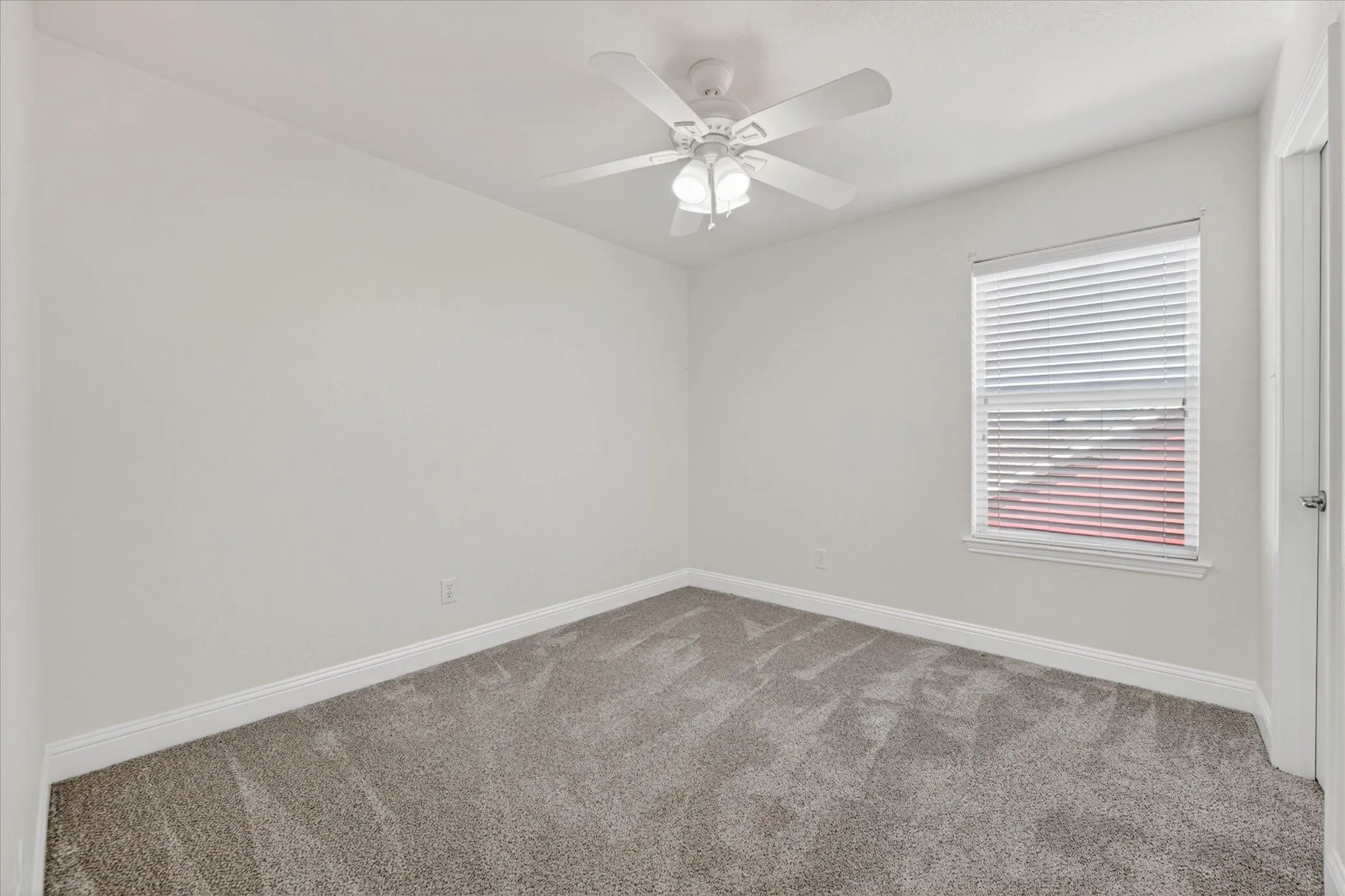 Bedroom Four Neutral wall tones with gray carpeting