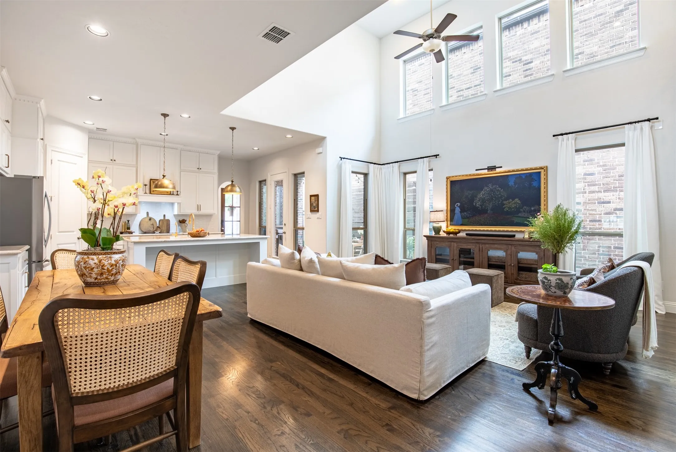 Living area featuring vaulted ceilings and wood floors. Spacious and Airy!