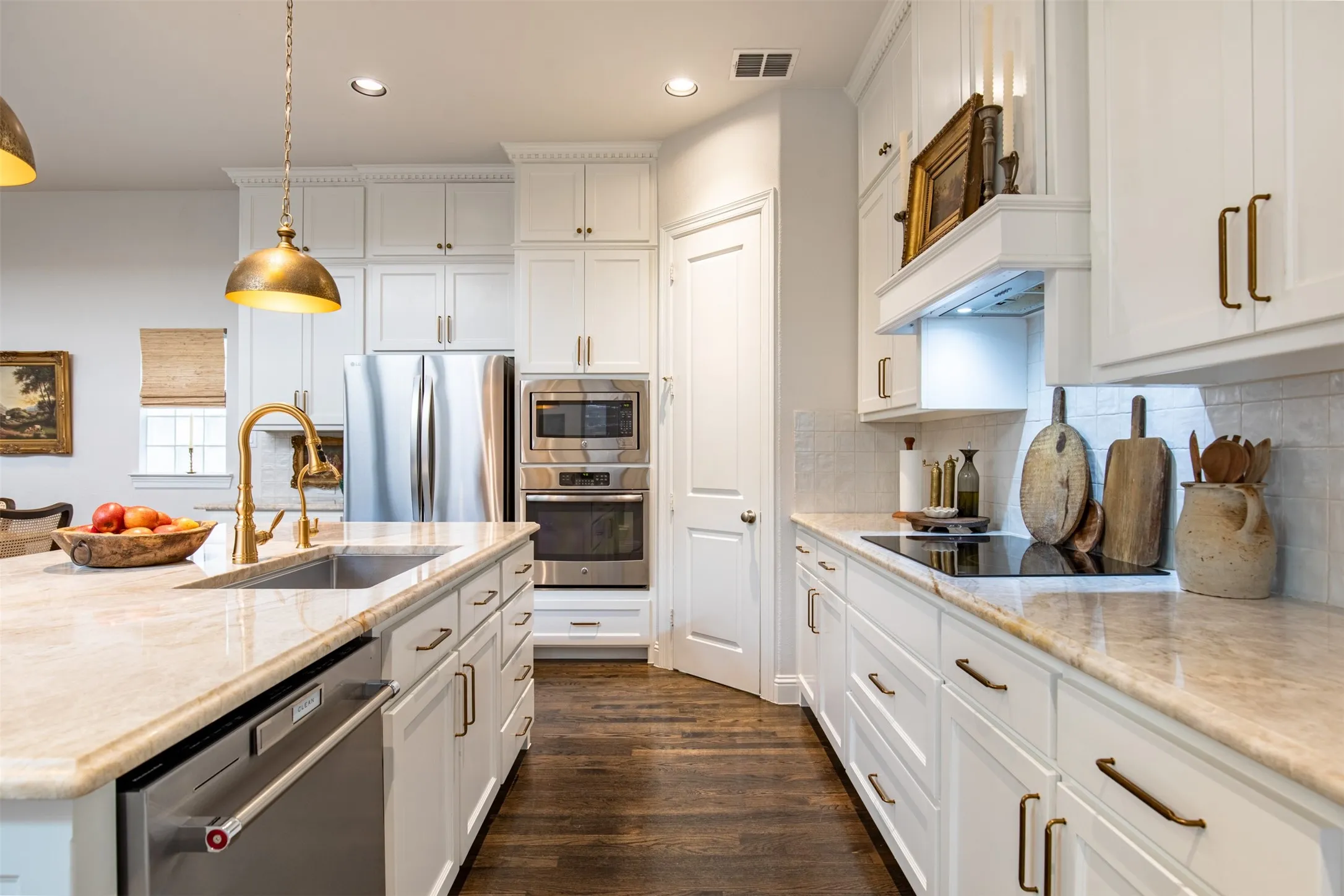 Kitchen with updated white cabinetry and built-in induction stove
