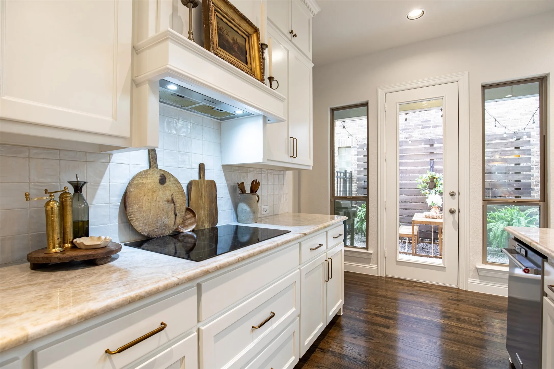 Kitchen with updated white cabinetry and built-in induction stove