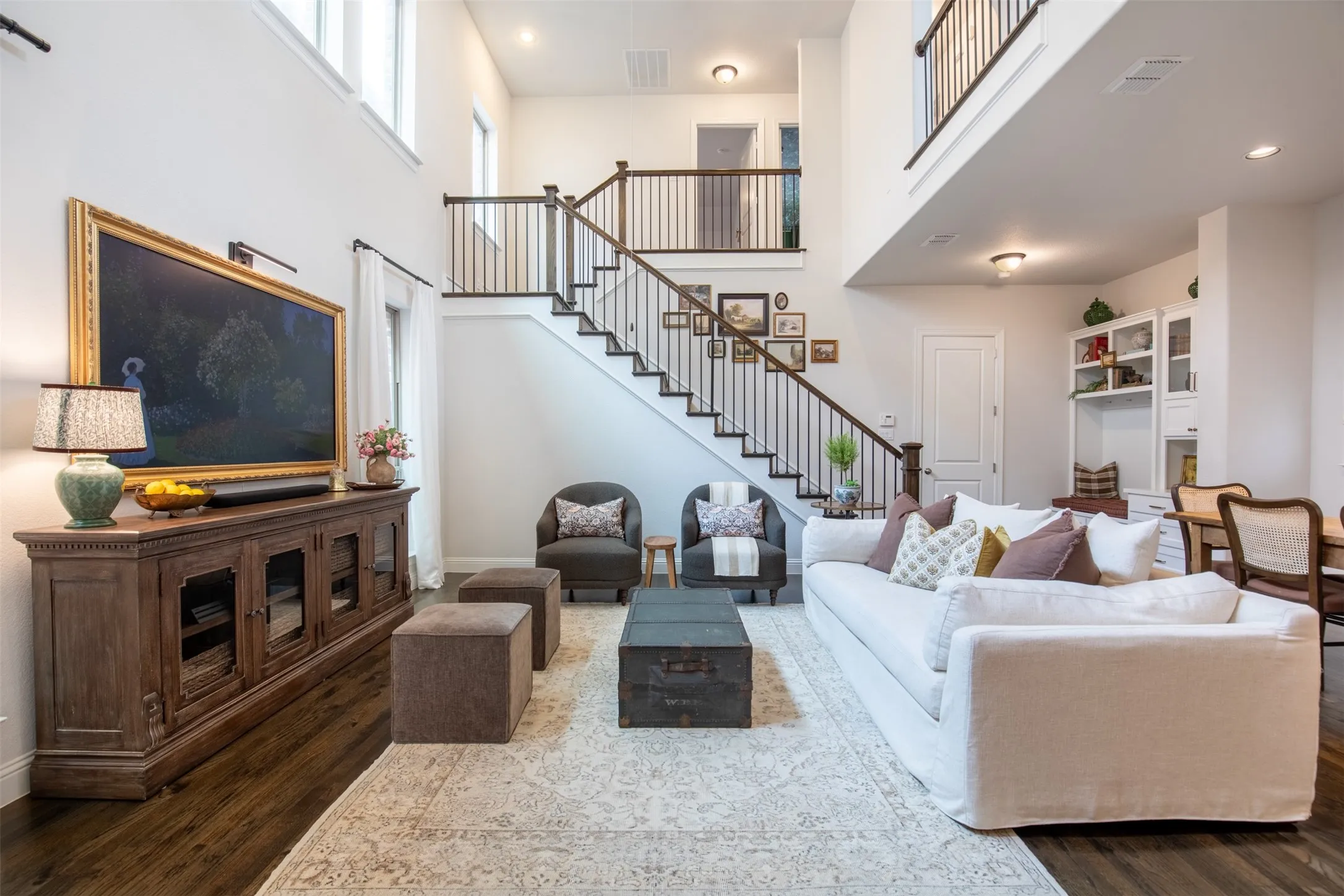 Living area featuring vaulted ceilings and wood floors. Spacious and Airy!